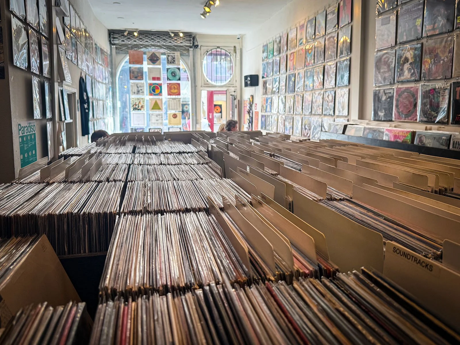 Photo from the interior of a busy record store in Amsterdam. It's part of a series of interviews with record store owners by Amsterdam Vinyl Club - organisers of community events for music lovers, record collectors and DJs.