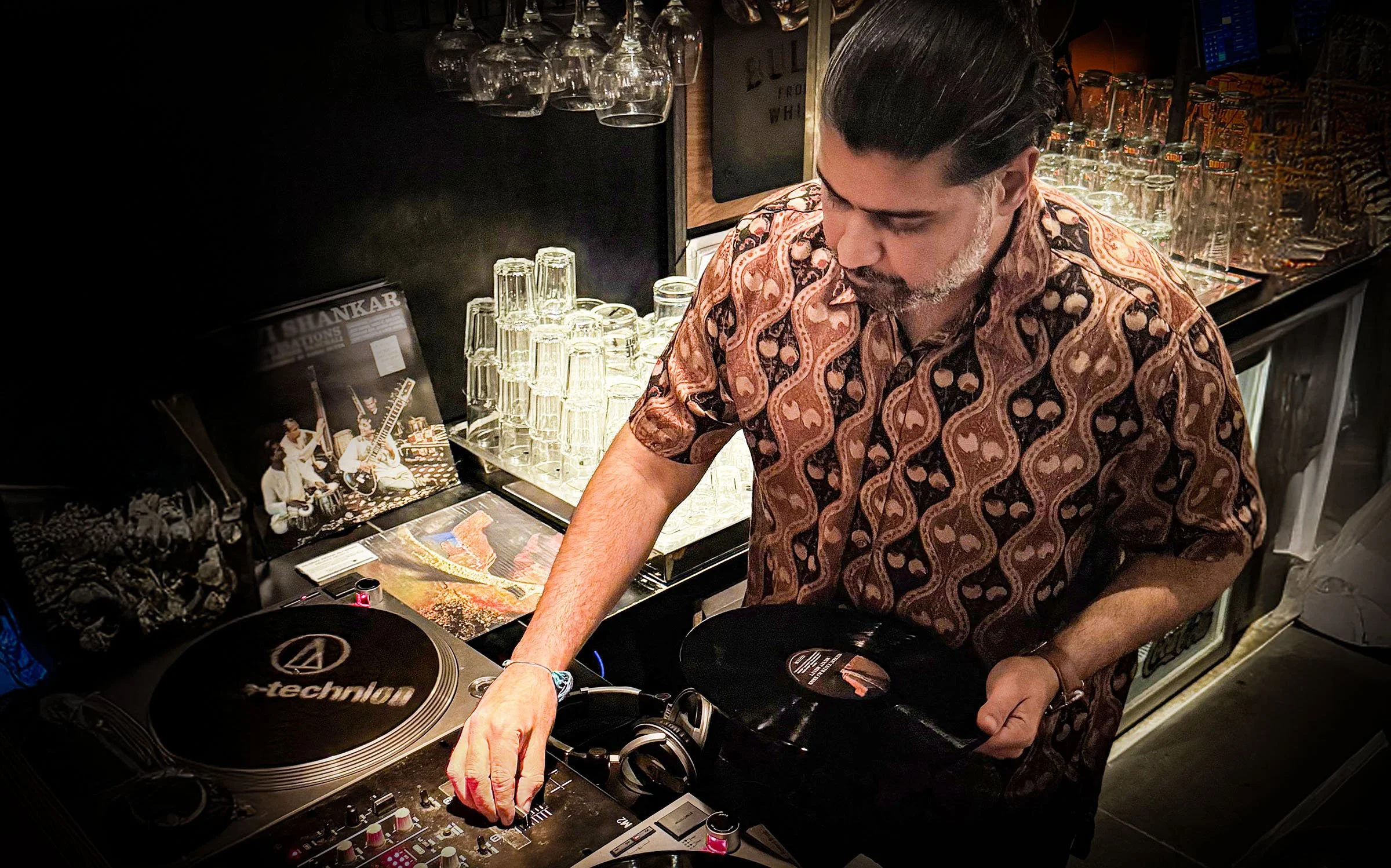 Deepak Nichani at the turntables playing a guest DJ set at Amsterdam Vinyl Club, a live music community event.