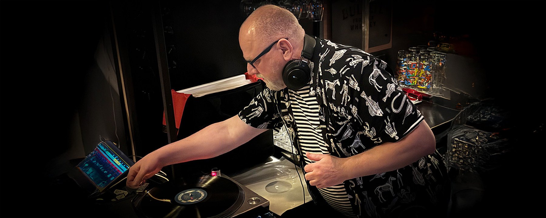 DJ Roland at the turntables playing a guest DJ set at Amsterdam Vinyl Club, a live music community event.