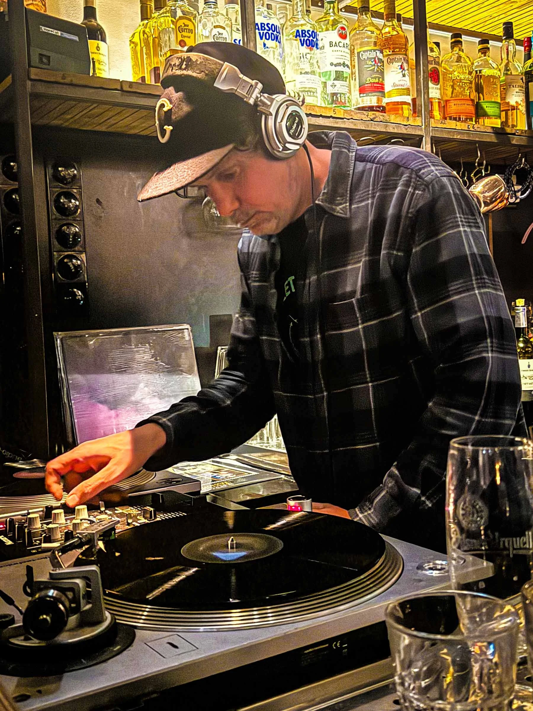 DJ Mouskovich at the turntables playing a guest DJ set at Amsterdam Vinyl Club, a live music community event.