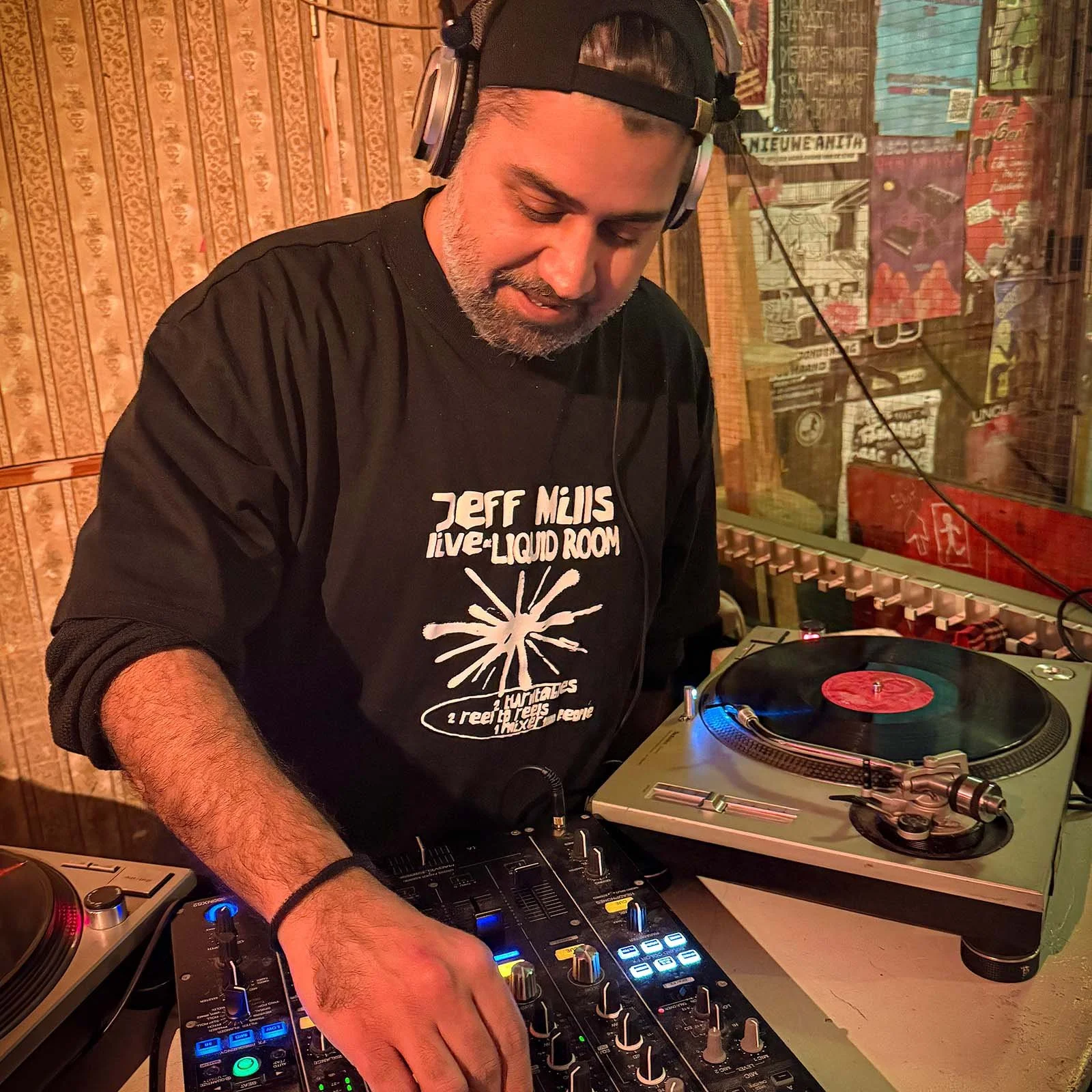 Deepak Nichani at the turntables playing a guest DJ set at Amsterdam Vinyl Club, a live music community event.
