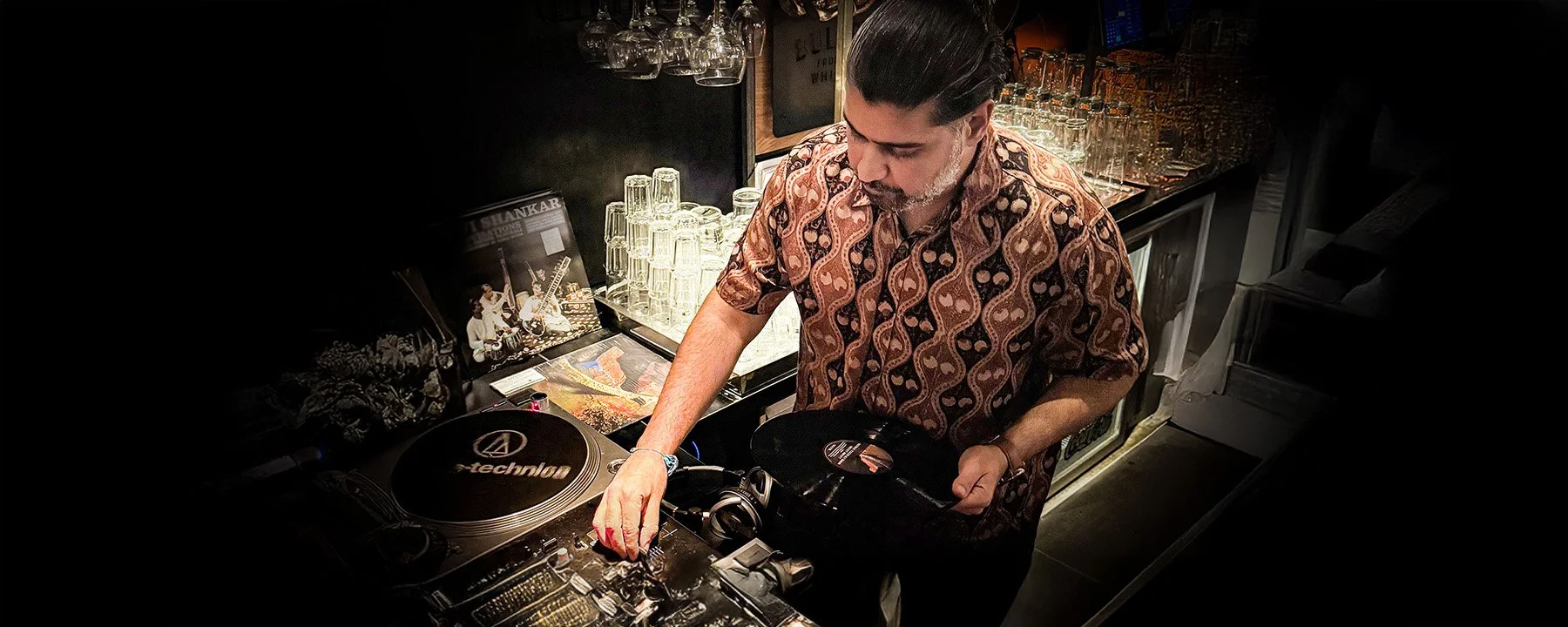 Deepak Nichani at the turntables playing a guest DJ set at Amsterdam Vinyl Club, a live music community event.
