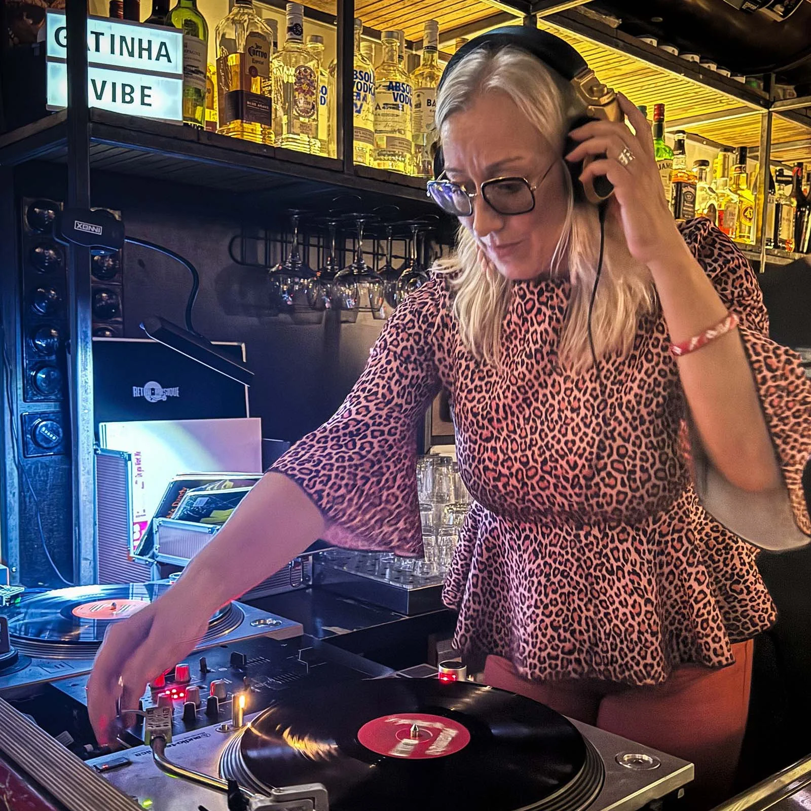 DJ Gatinha at the turntables playing a guest DJ set at Amsterdam Vinyl Club, a live music community event.
