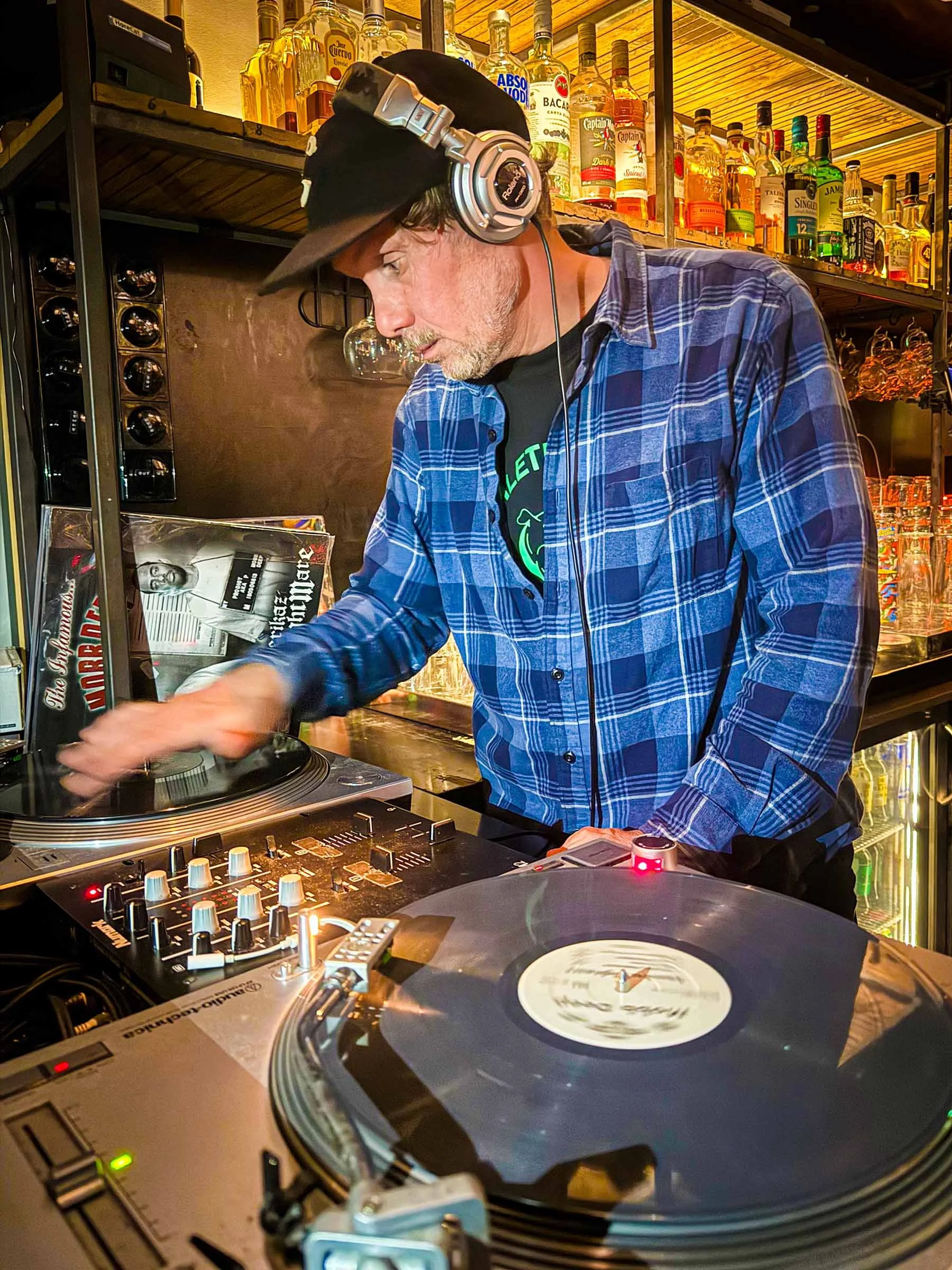 DJ Mouskovich at the turntables playing a guest DJ set at Amsterdam Vinyl Club, a live music community event.