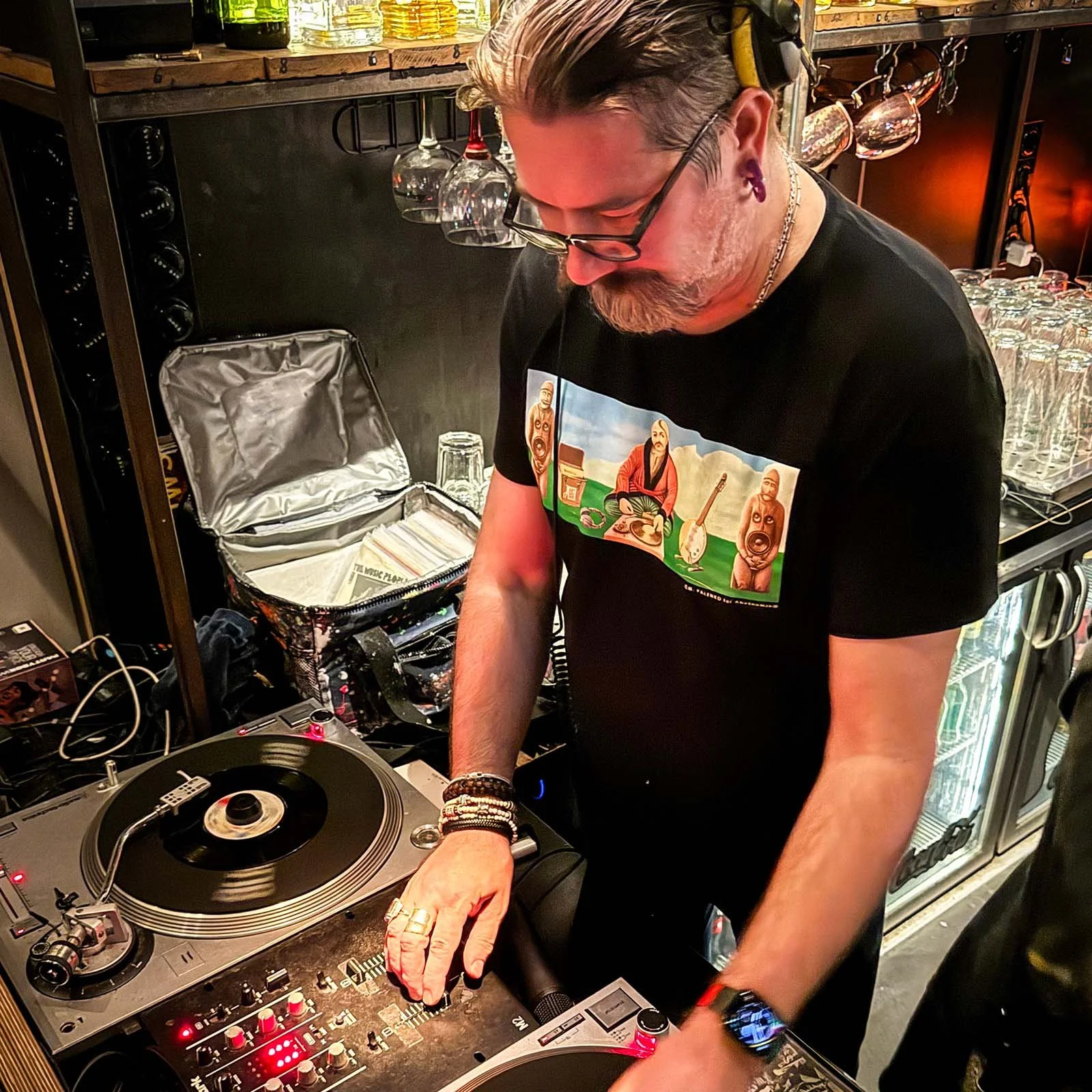 DJ Necto Lucas at the turntables playing a guest DJ set at Amsterdam Vinyl Club, a live music community event.