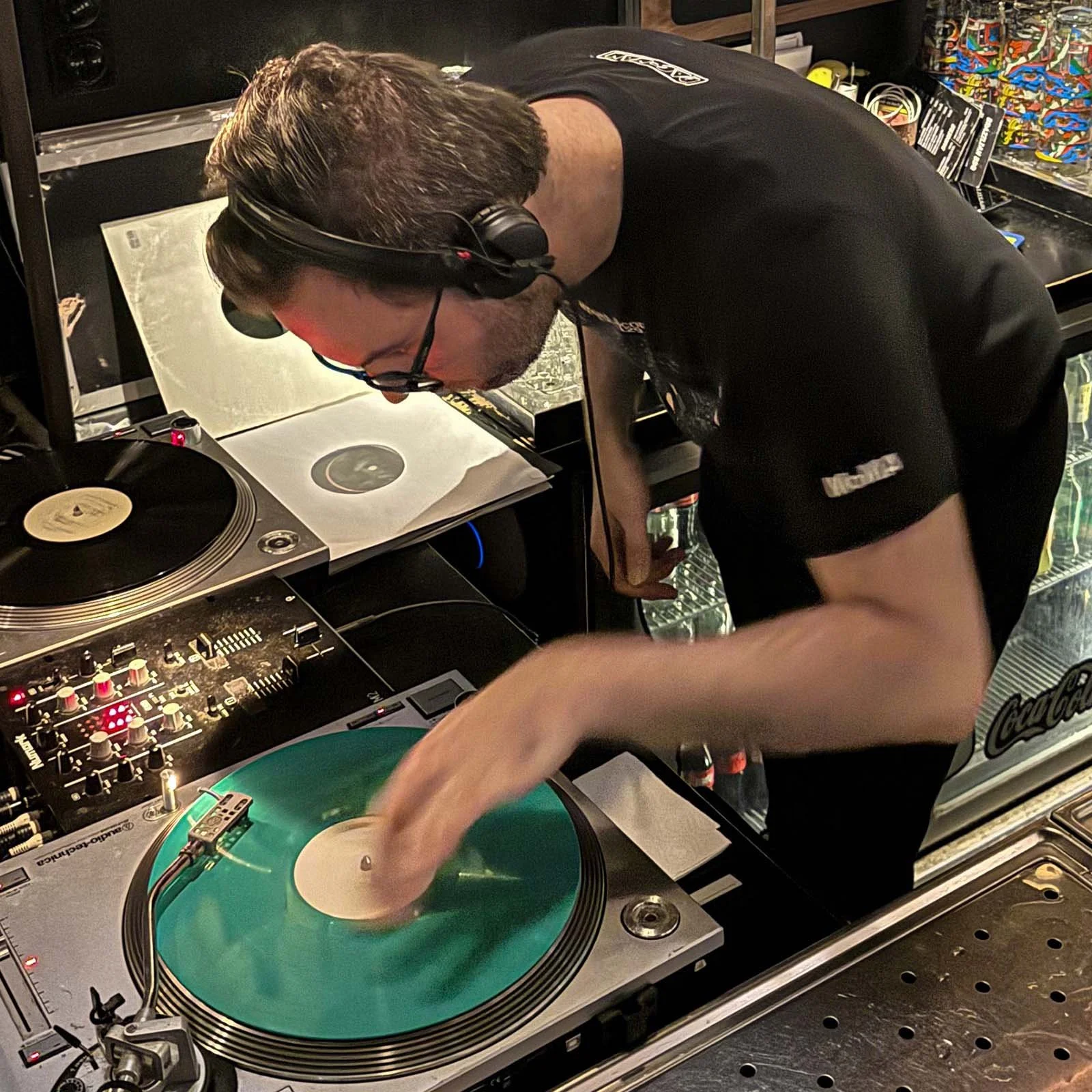 DJ Ermac at the turntables playing a guest DJ set at Amsterdam Vinyl Club, a live music community event.