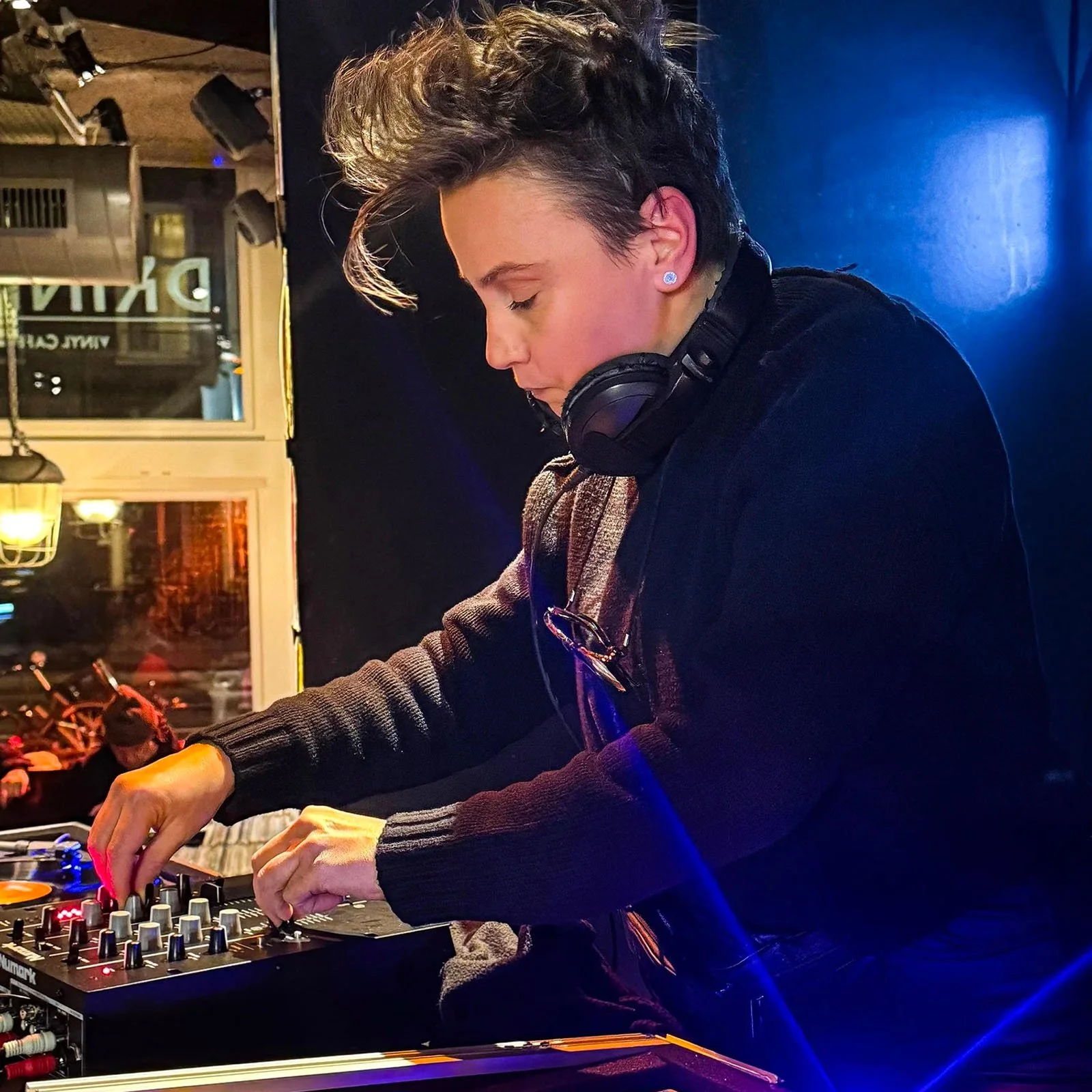 Nympho at the turntables playing a guest DJ set at Amsterdam Vinyl Club, a live music community event.