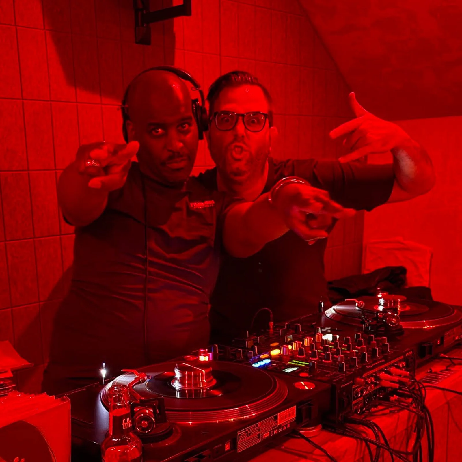 DJ Ermac and DJ Tea & 2 Sugars at the turntables playing a guest DJ set at Amsterdam Vinyl Club, a live music community event.