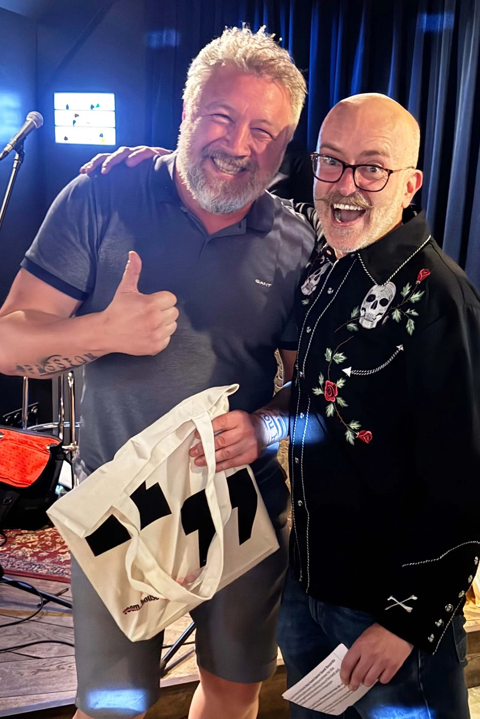 A quiz winner receives his prize bag after winning the quiz at an Amsterdam Vinyl Club live event.