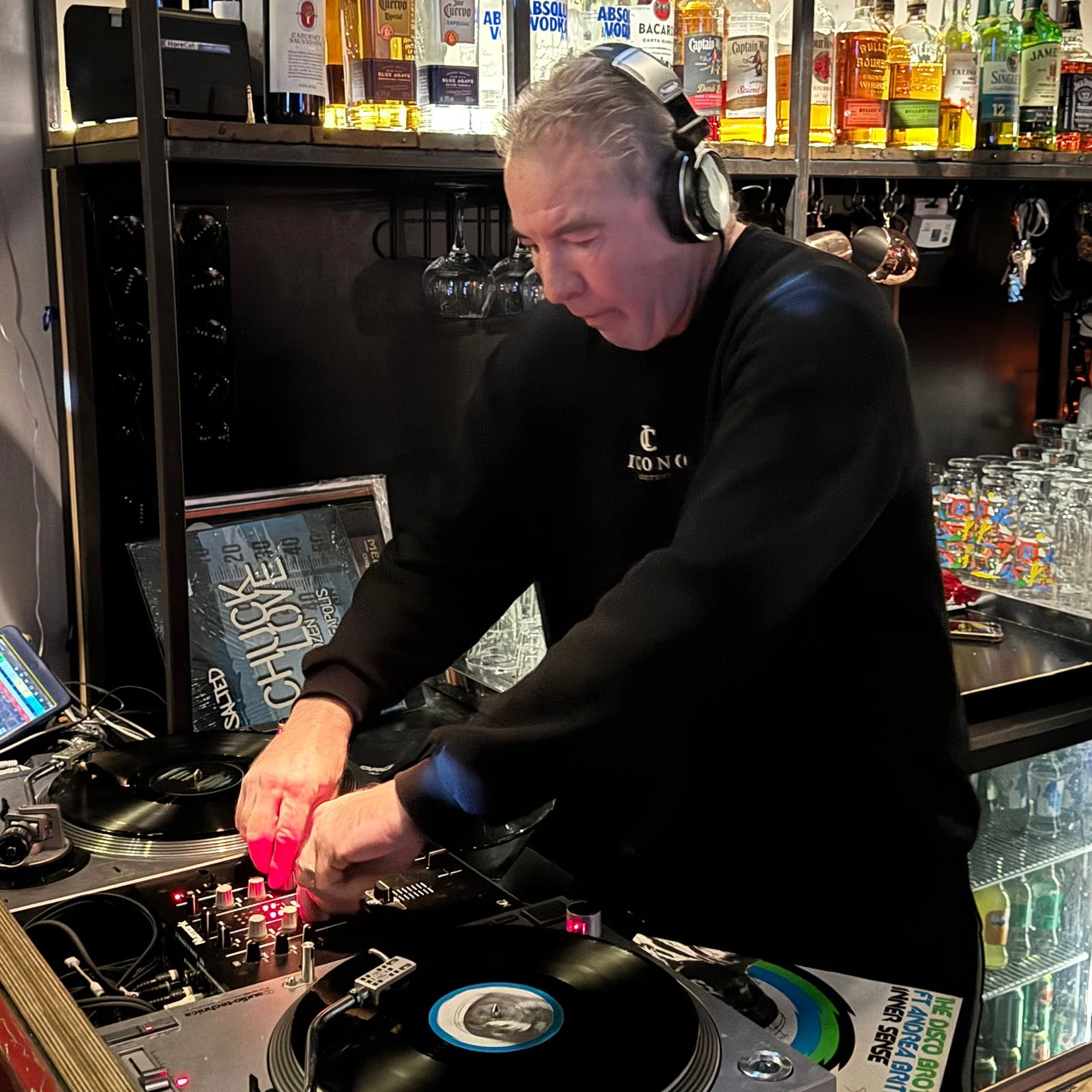 DJ Jaimy at the turntables playing a guest DJ set at Amsterdam Vinyl Club, a live music community event.