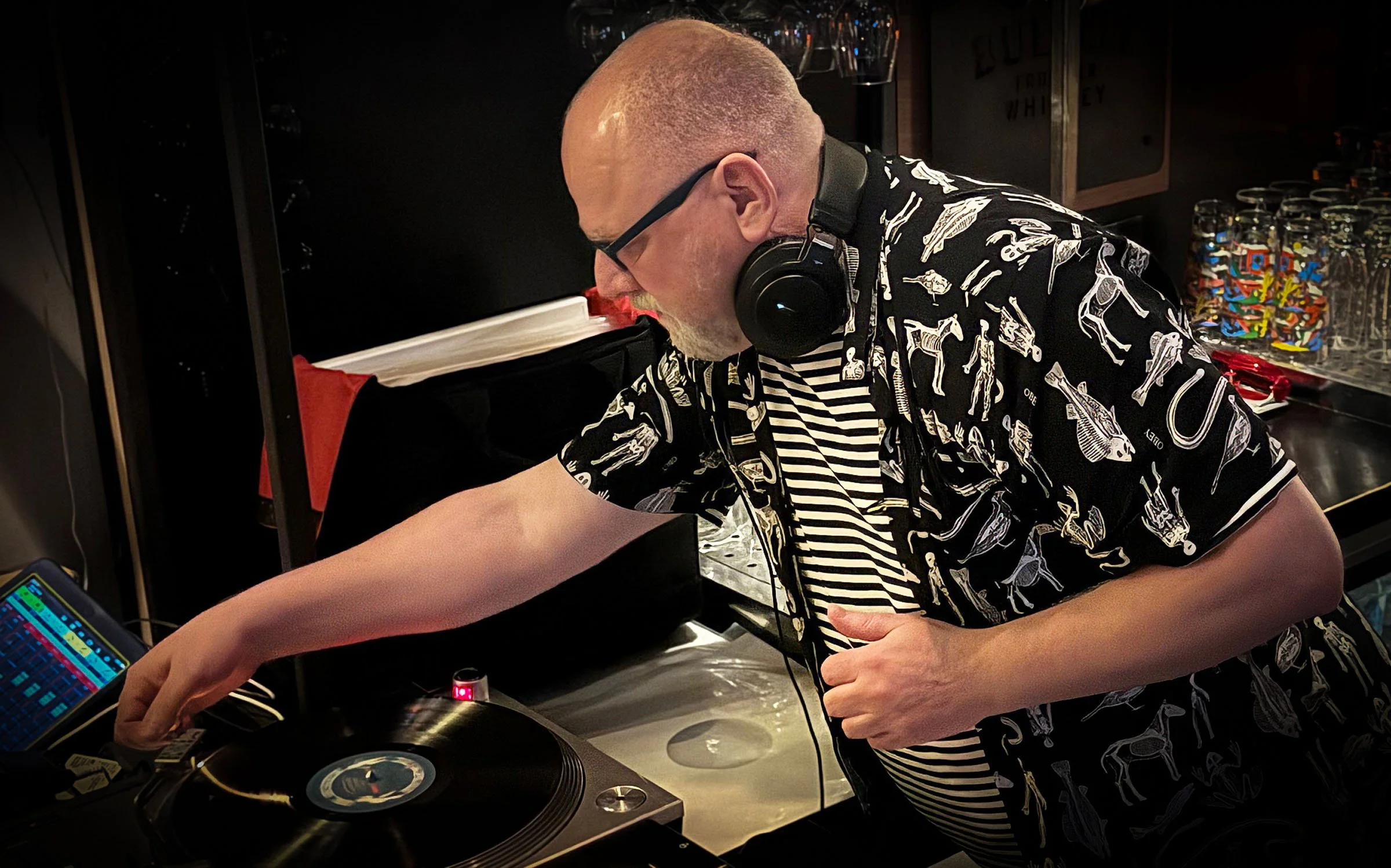 DJ Roland at the turntables playing a guest DJ set at Amsterdam Vinyl Club, a live music community event.