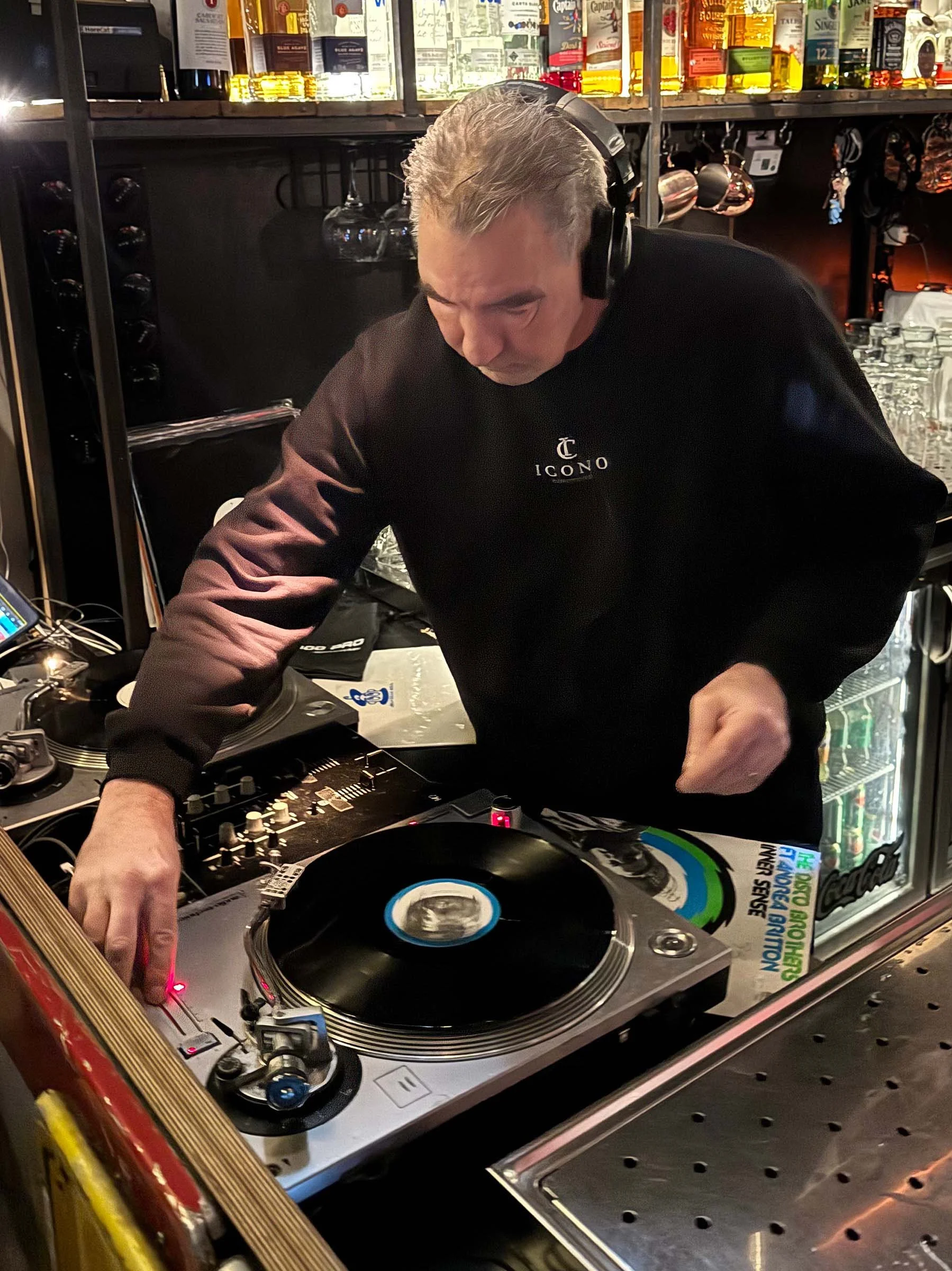 DJ Jaimy at the turntables playing a guest DJ set at Amsterdam Vinyl Club, a live music community event.