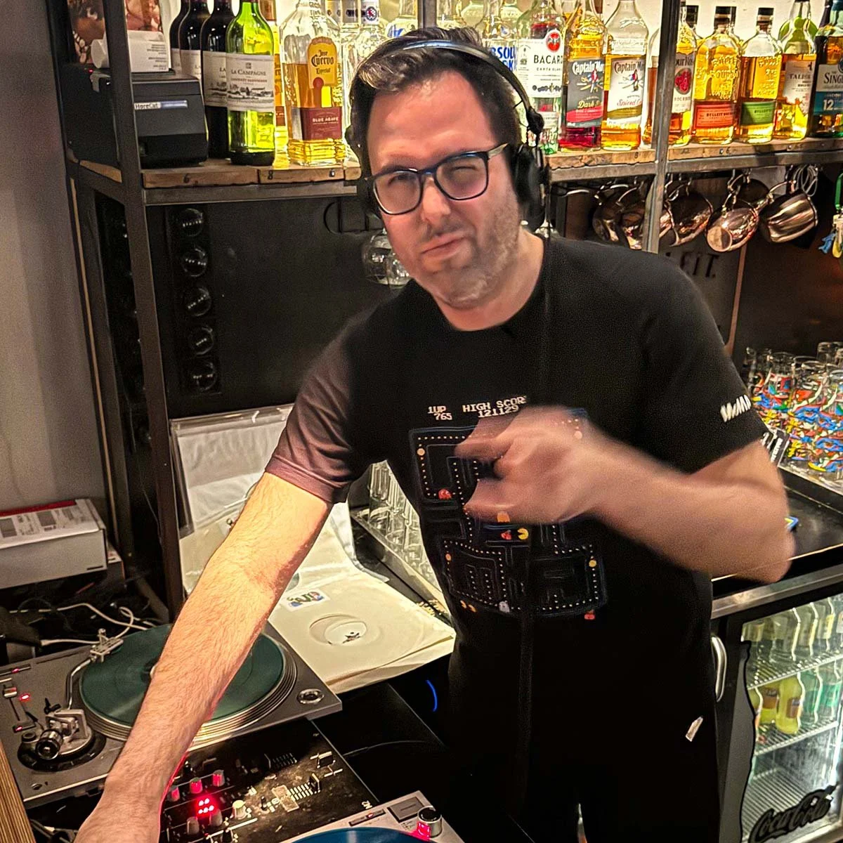 DJ Ermac at the turntables playing a guest DJ set at Amsterdam Vinyl Club, a live music community event.