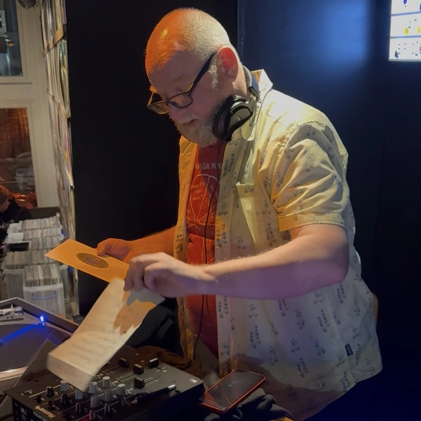 DJ Roland at the turntables playing a guest DJ set at Amsterdam Vinyl Club, a live music community event.