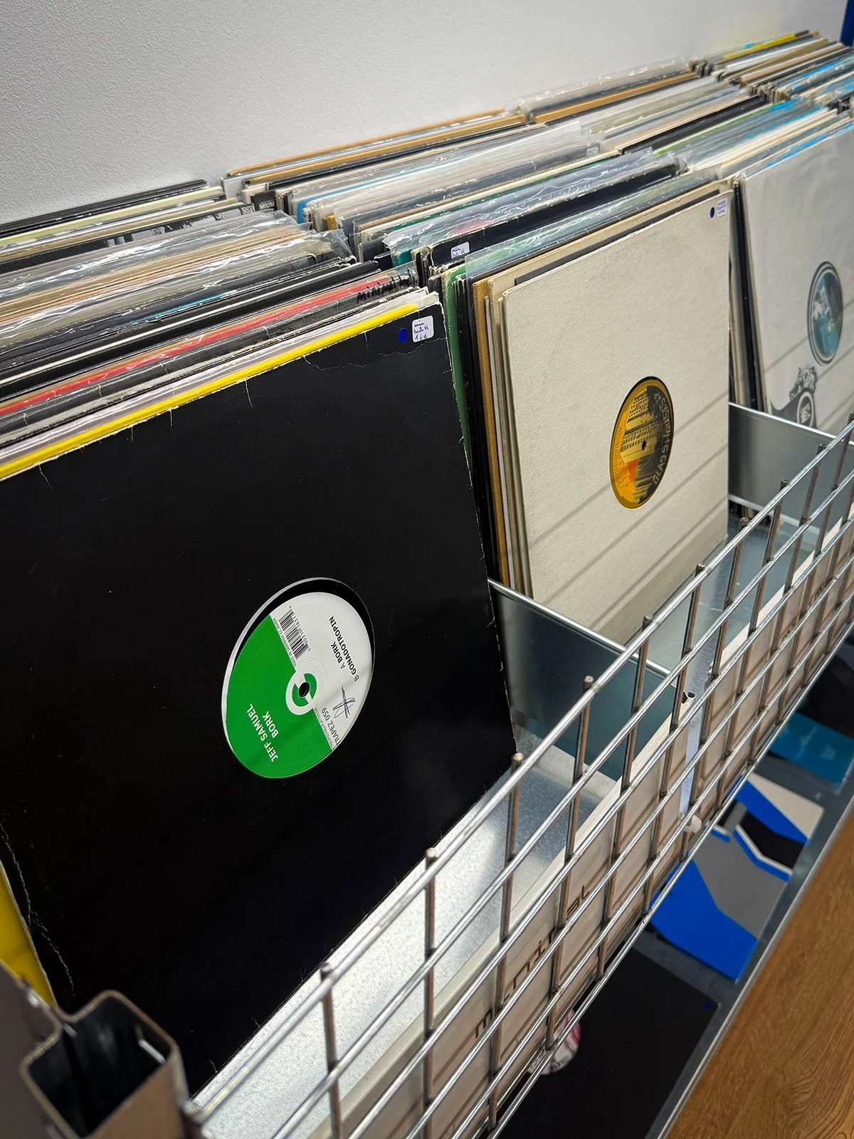 The interior of GOT.DRIP Streetwear and Records, a vinyl and clothing store in Amsterdam, Netherlands. There are hundreds of vinyl records on display.