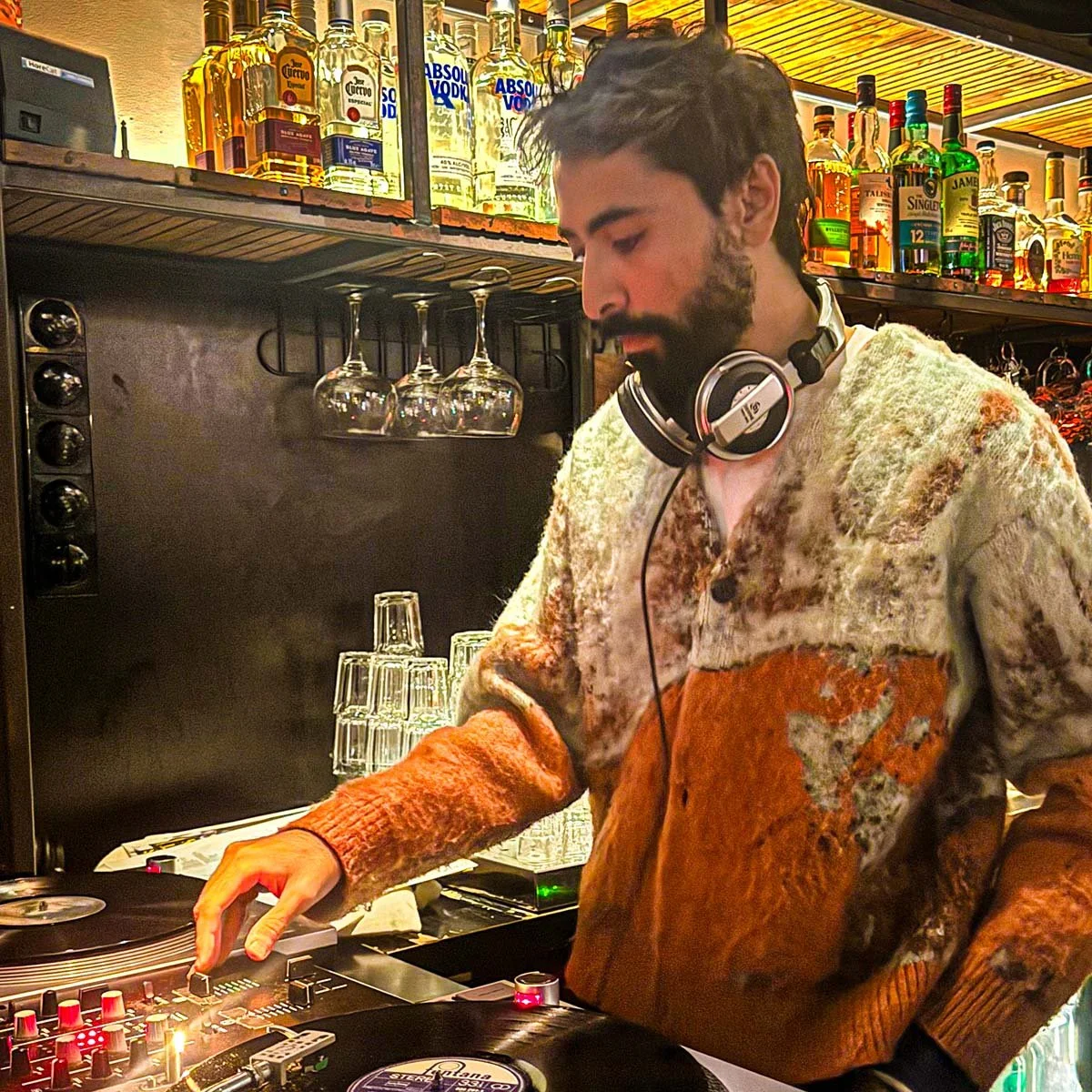 Adnan Samman at the turntables playing a guest DJ set at Amsterdam Vinyl Club, a live music community event.