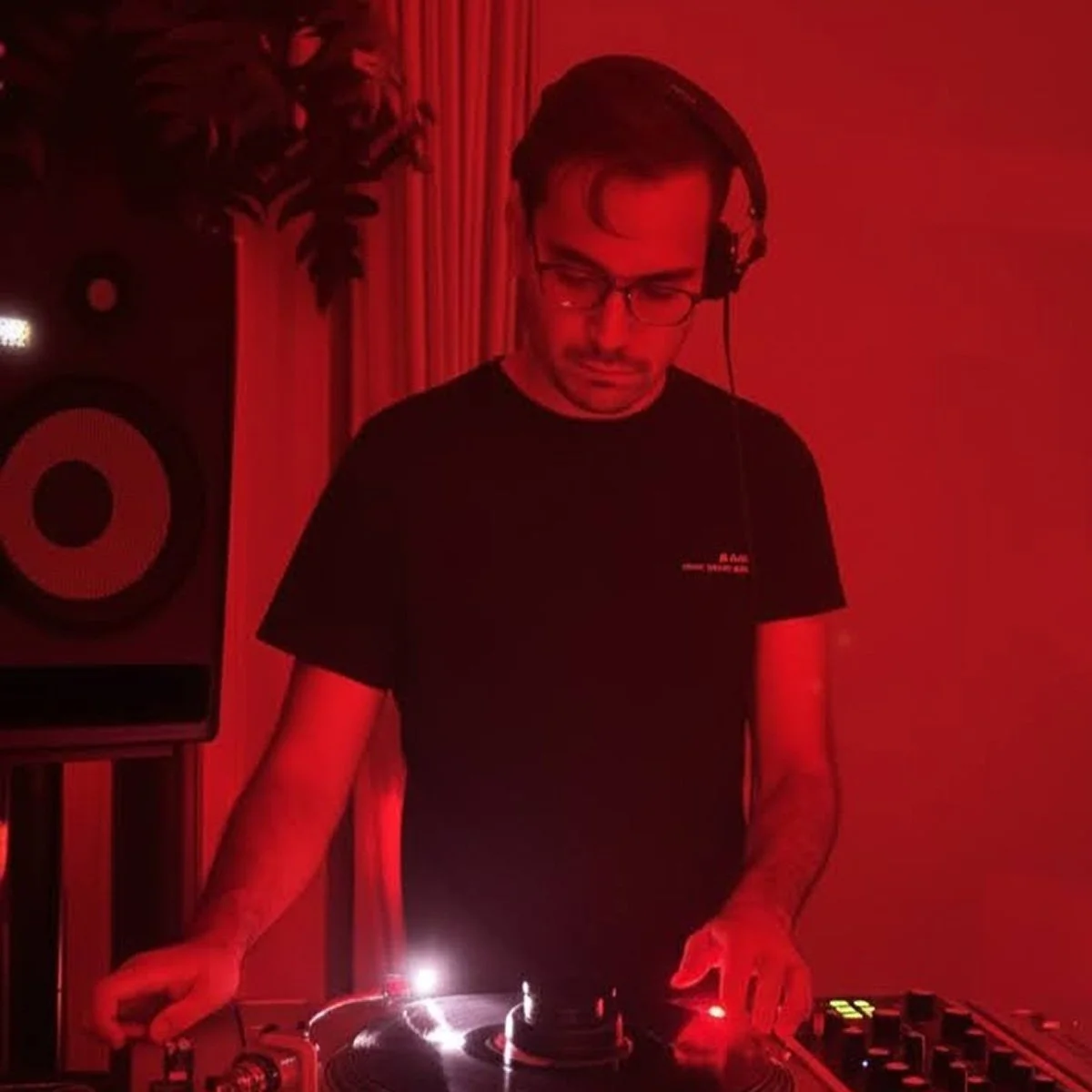 Sean Sanchez at the turntables playing a guest DJ set at Amsterdam Vinyl Club, a live music community event.