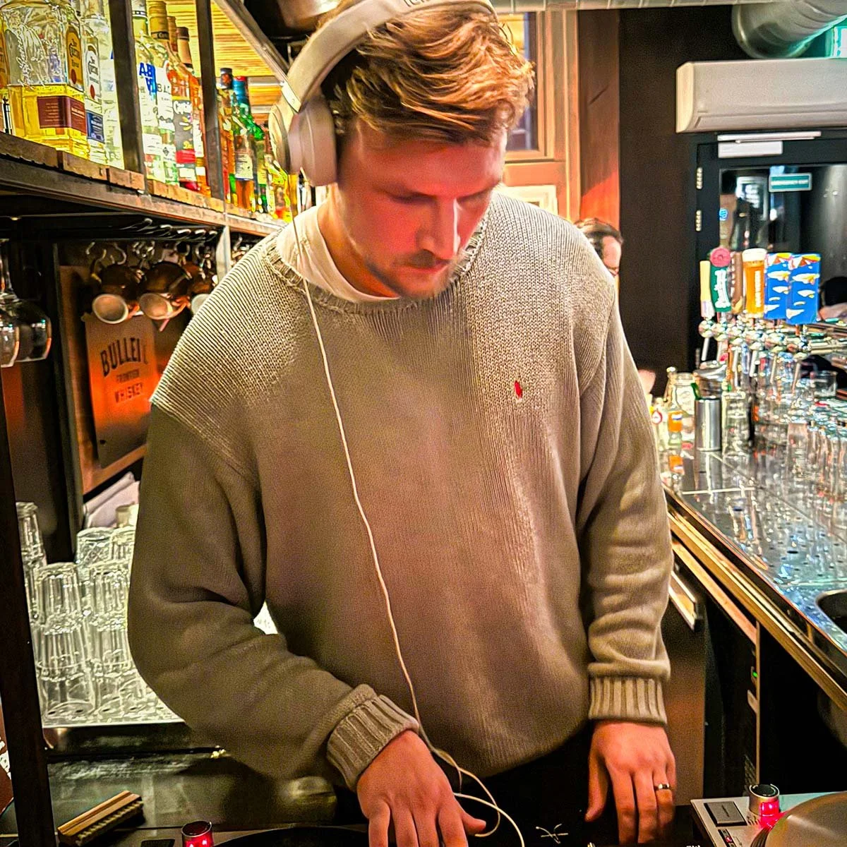 farmer (Juri) at the turntables playing a guest DJ set at Amsterdam Vinyl Club, a live music community event.