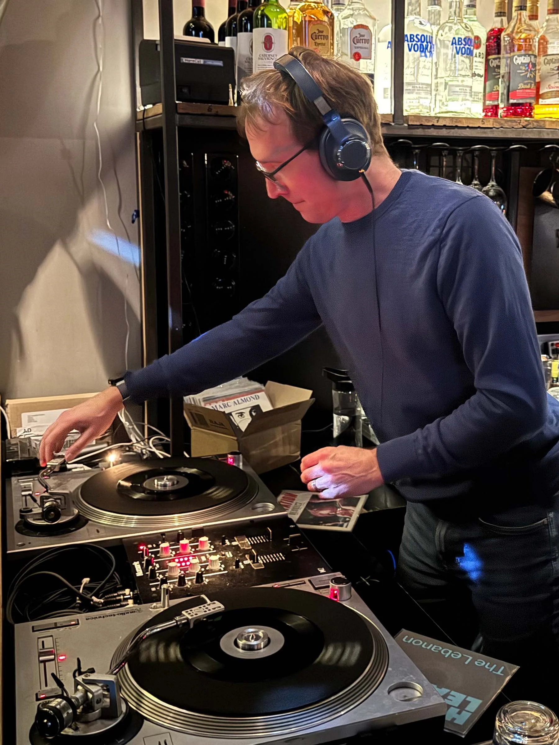 DJ Multimuck at the turntables playing a guest DJ set at Amsterdam Vinyl Club, a live music community event.