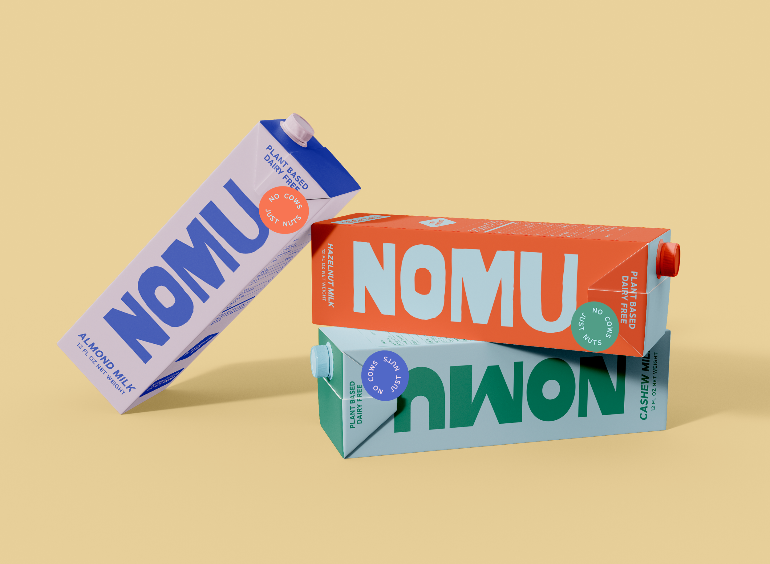 Three cartons of plant-based dairy-free milk, almond, hazelnut, and cashew, on a beige background. The almond milk carton is purple and white, the hazelnut milk carton is orange and light blue, and the cashew milk carton is green and light blue.