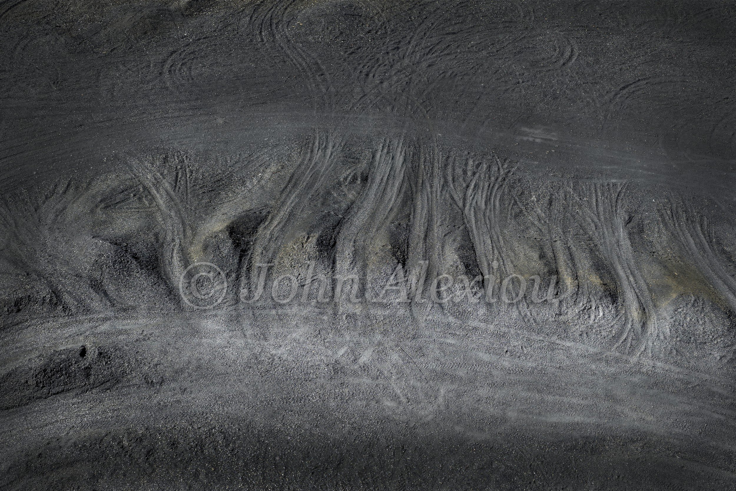 06 · Lines in the Land: An overhead study of channels and curved tracks across a dark exposed bank.

© John Alexiou · 2025 · Mocanaqua