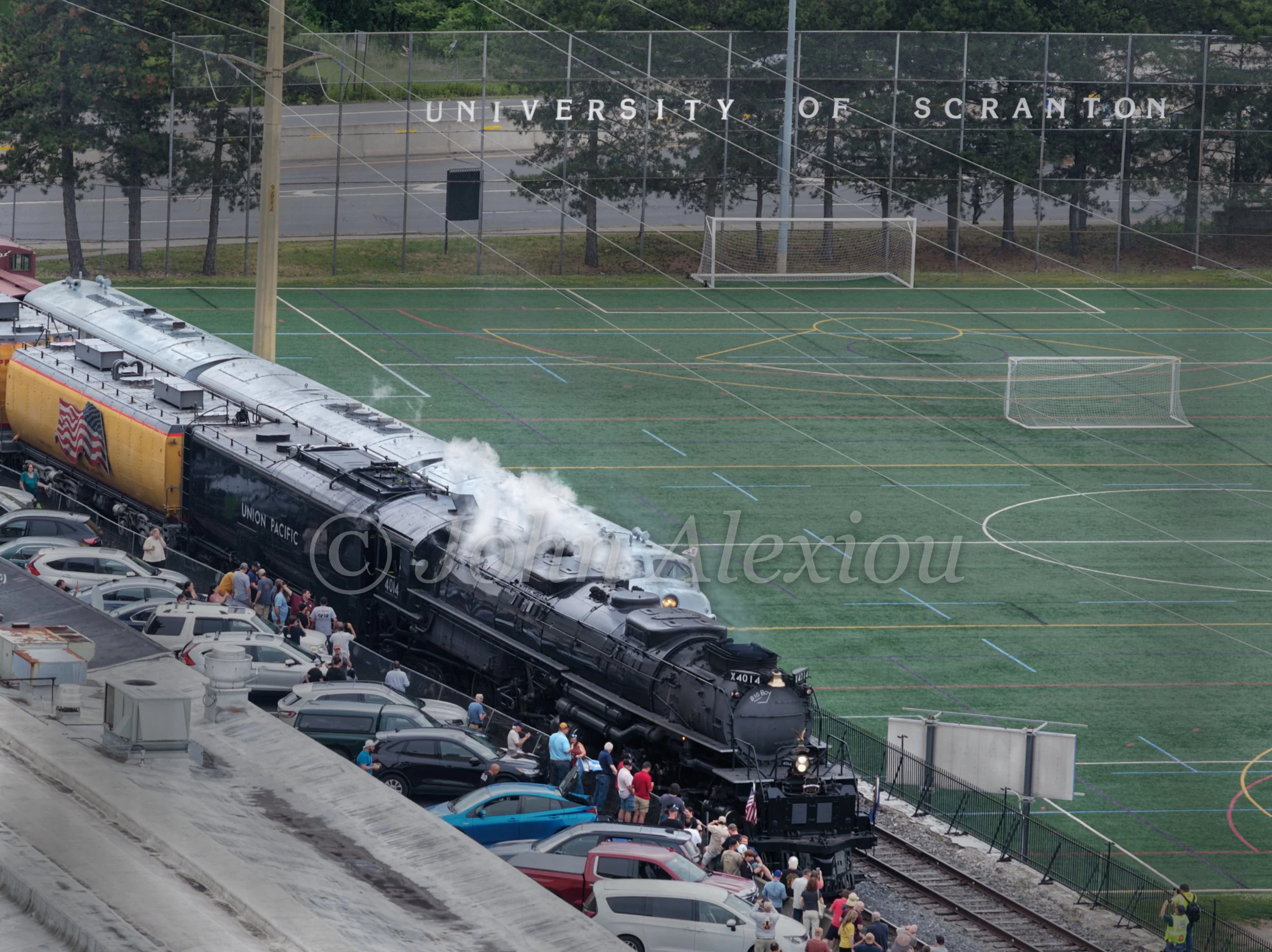 09 · Big Boy Comes to Town
Union Pacific Big Boy No. 4014 passes beside the University of Scranton's fields as people gather along the tracks.
© John Alexiou · 2026 · Steamtown, Scranton