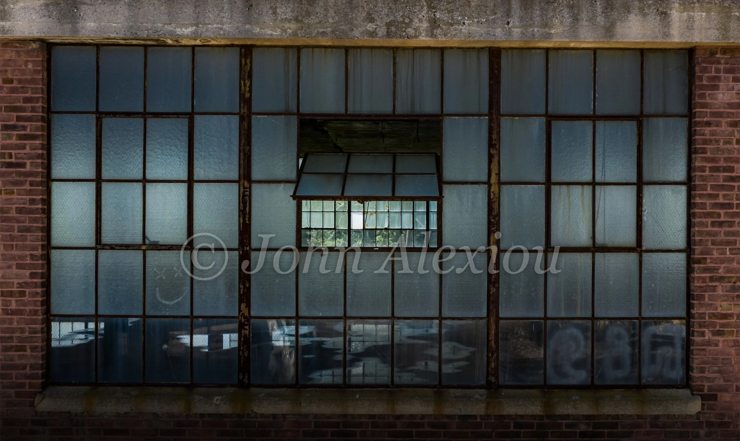 04 · A Window Within a Window
An open pane frames another bank of windows across the empty factory.
© John Alexiou · 2019 · Scranton Lace Company