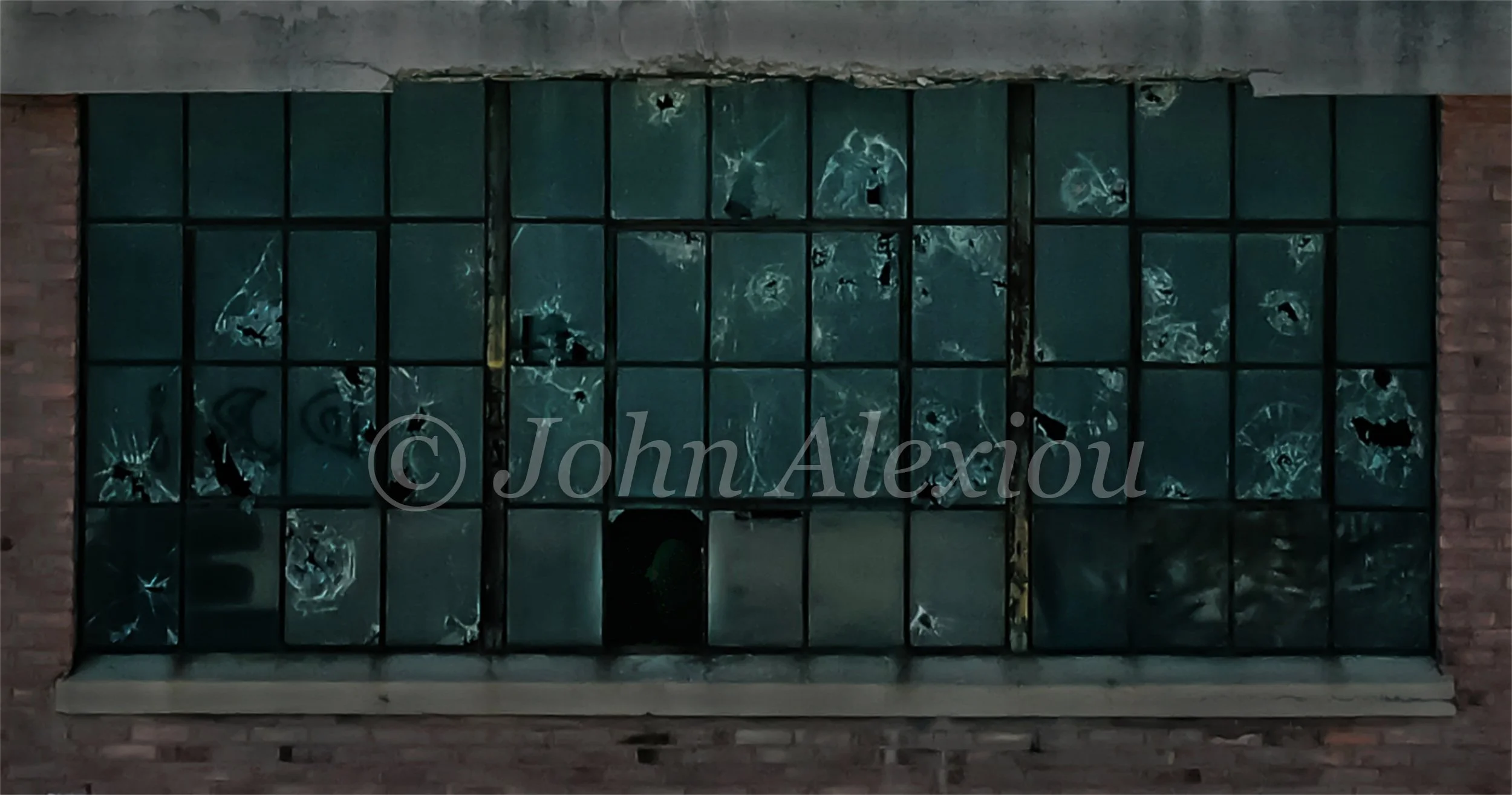09 · Broken Pieces
Cracked and missing panes interrupt a tight grid of dark green glass.
© John Alexiou · 2019 · Scranton Lace Company