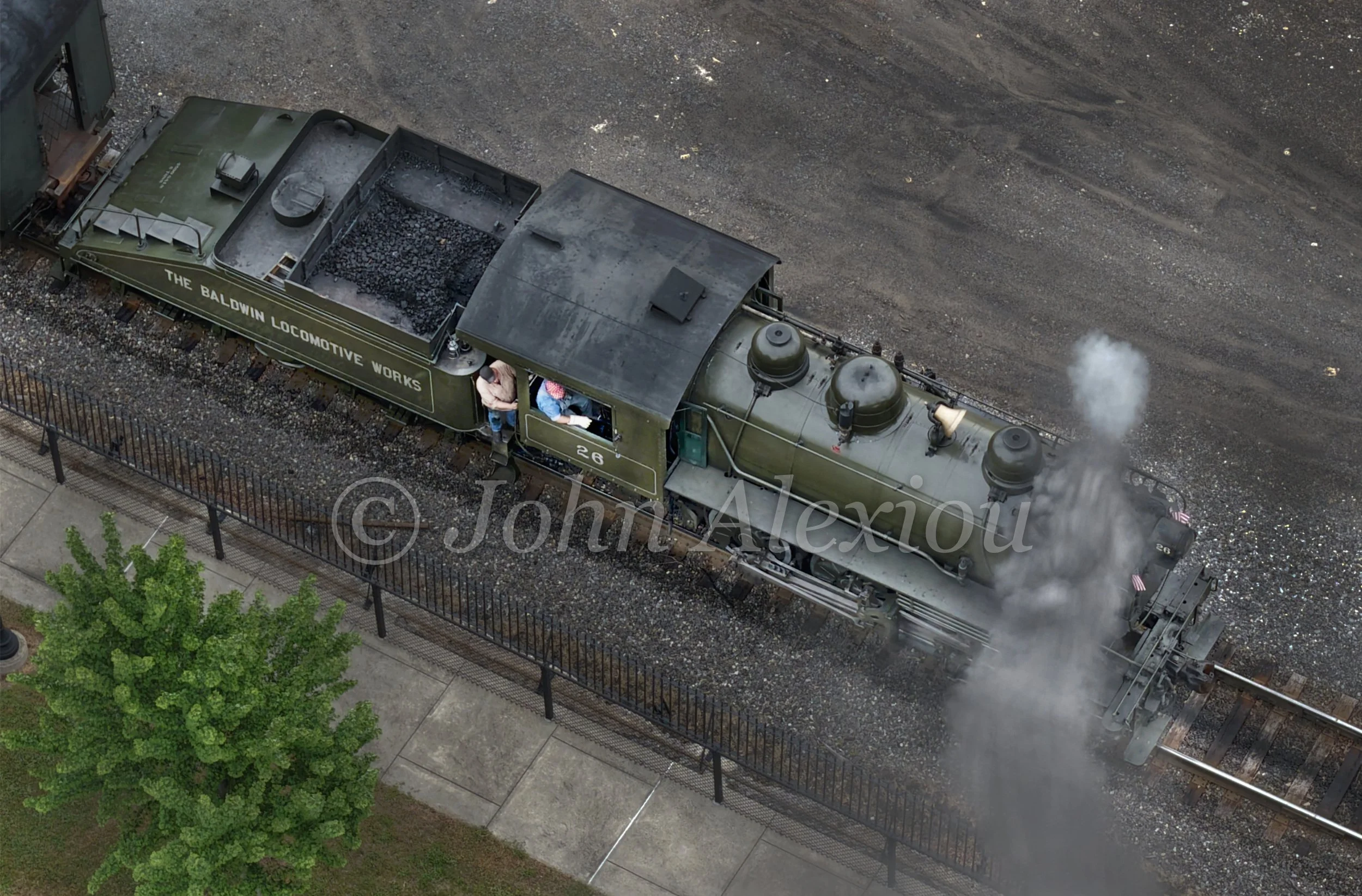 08 · A Smaller Kind of Steam
Steamtown's green Baldwin No. 26 releases a small plume of steam beside its sloped tender.
© John Alexiou · 2026 · Steamtown, Scranton