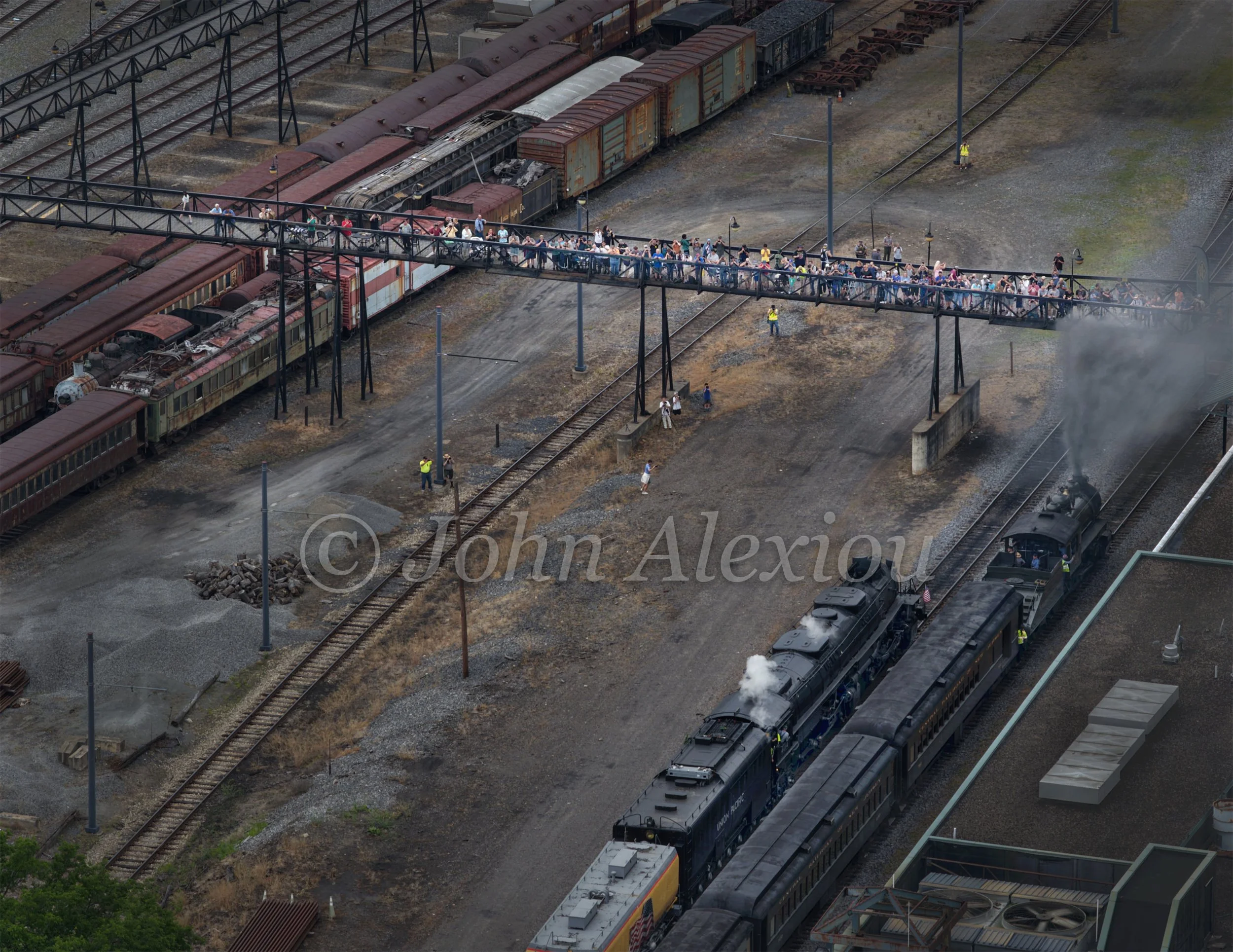 11 · Steam Through the Yard
Big Boy No. 4014 moves through Steamtown's rail yard beneath the elevated walkway and a rising plume of steam.
© John Alexiou · 2026 · Steamtown, Scranton