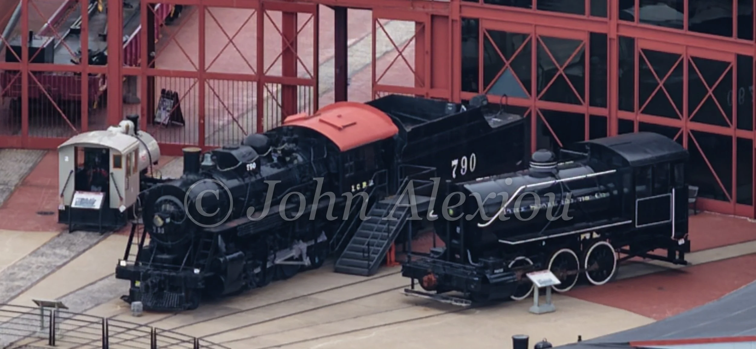 05 · Iron at Rest
Illinois Central No. 790 and another preserved locomotive stand outside Steamtown's red roundhouse doors.
© John Alexiou · 2026 · Steamtown, Scranton