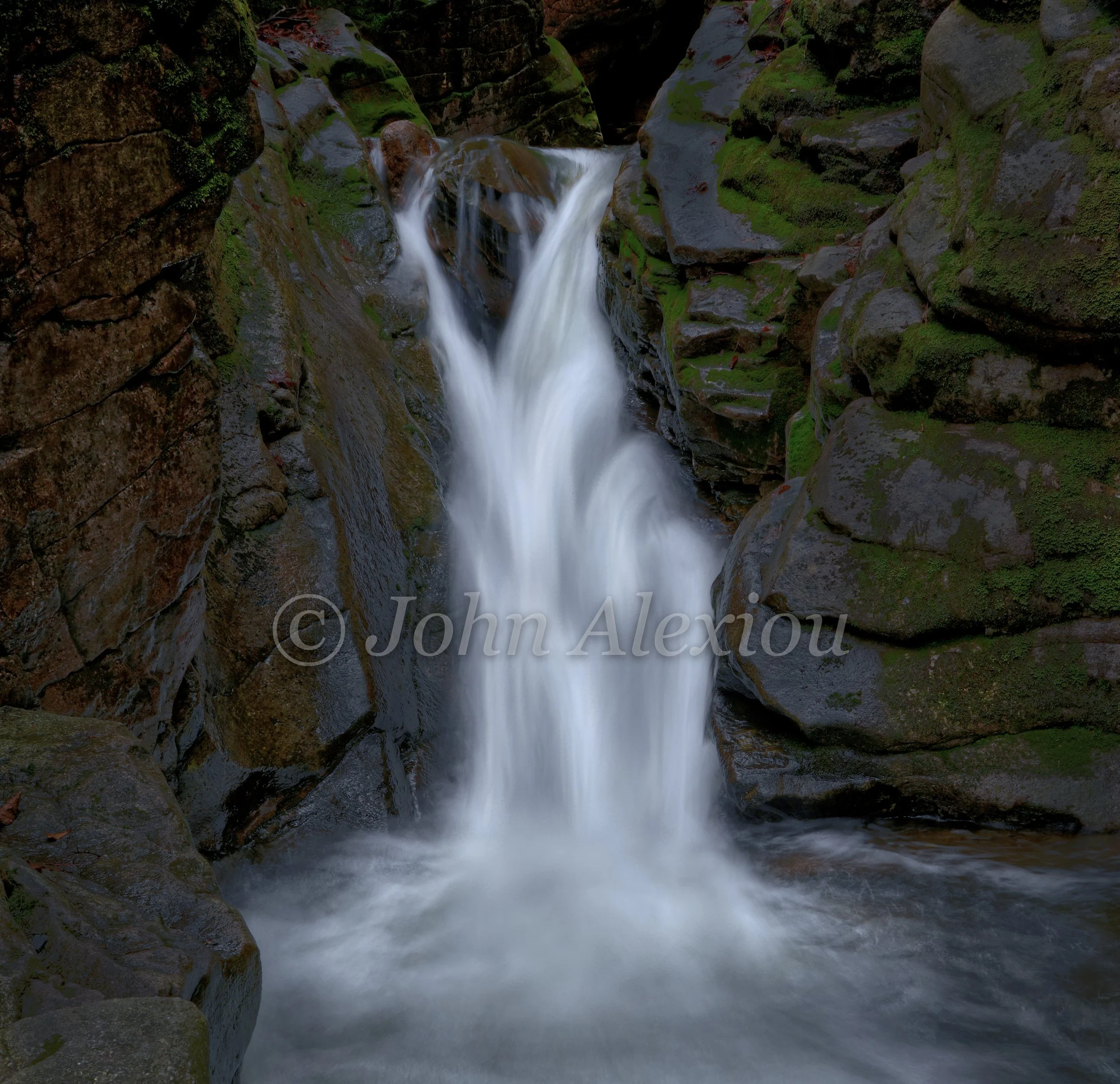 04 · Where the Water Opens
Water splits around the upper rock, then gathers into a bright cascade above the pool.
© John Alexiou · 2026 · Northeast Pennsylvania