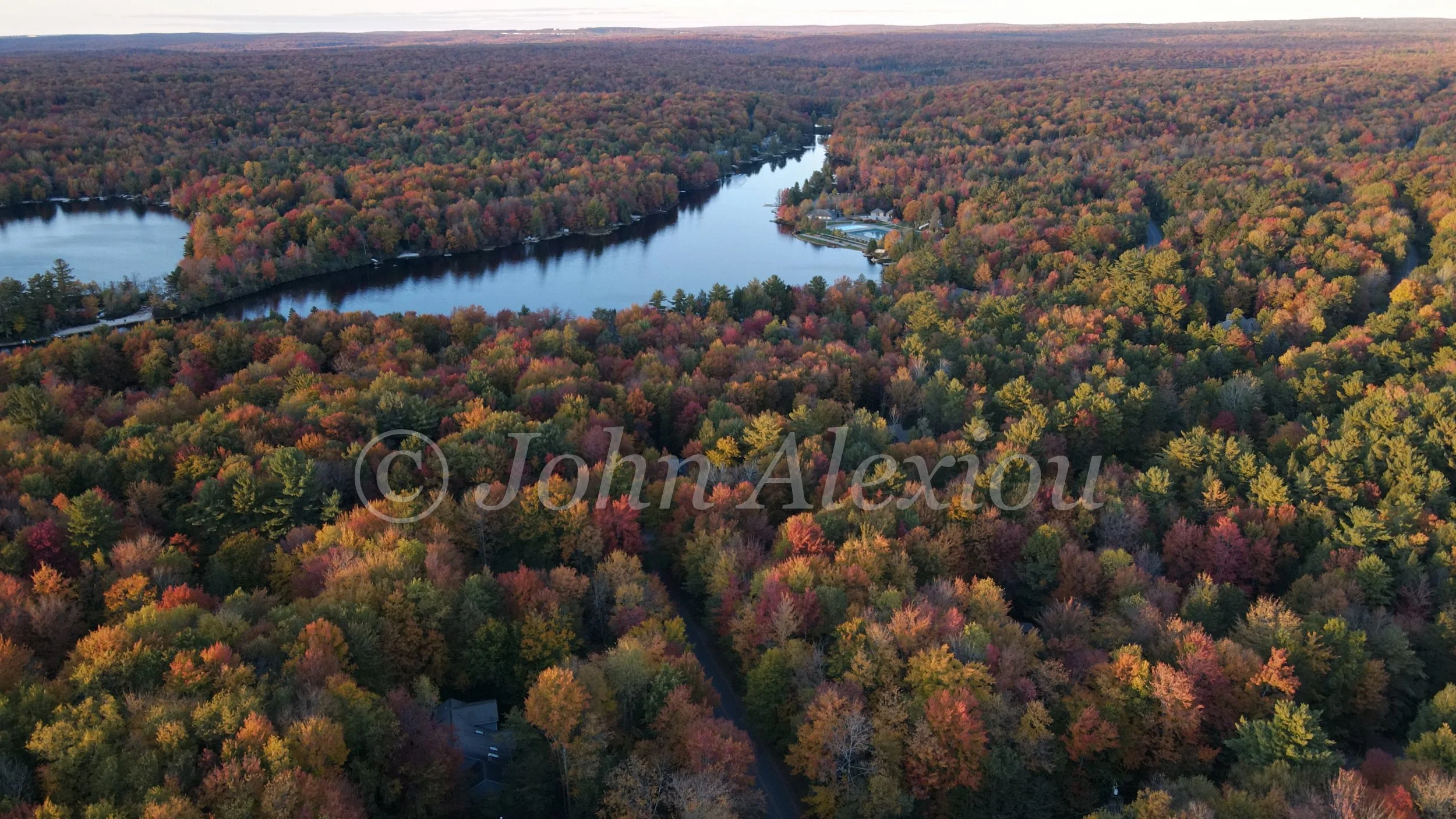 01 · A Lake in the Autumn Forest
A narrow lake curves through a broad canopy of orange, gold and lingering green.
© John Alexiou · 2022
DJI FC3170 · 4.5 mm · f/2.8 · 1/10 s · ISO 400