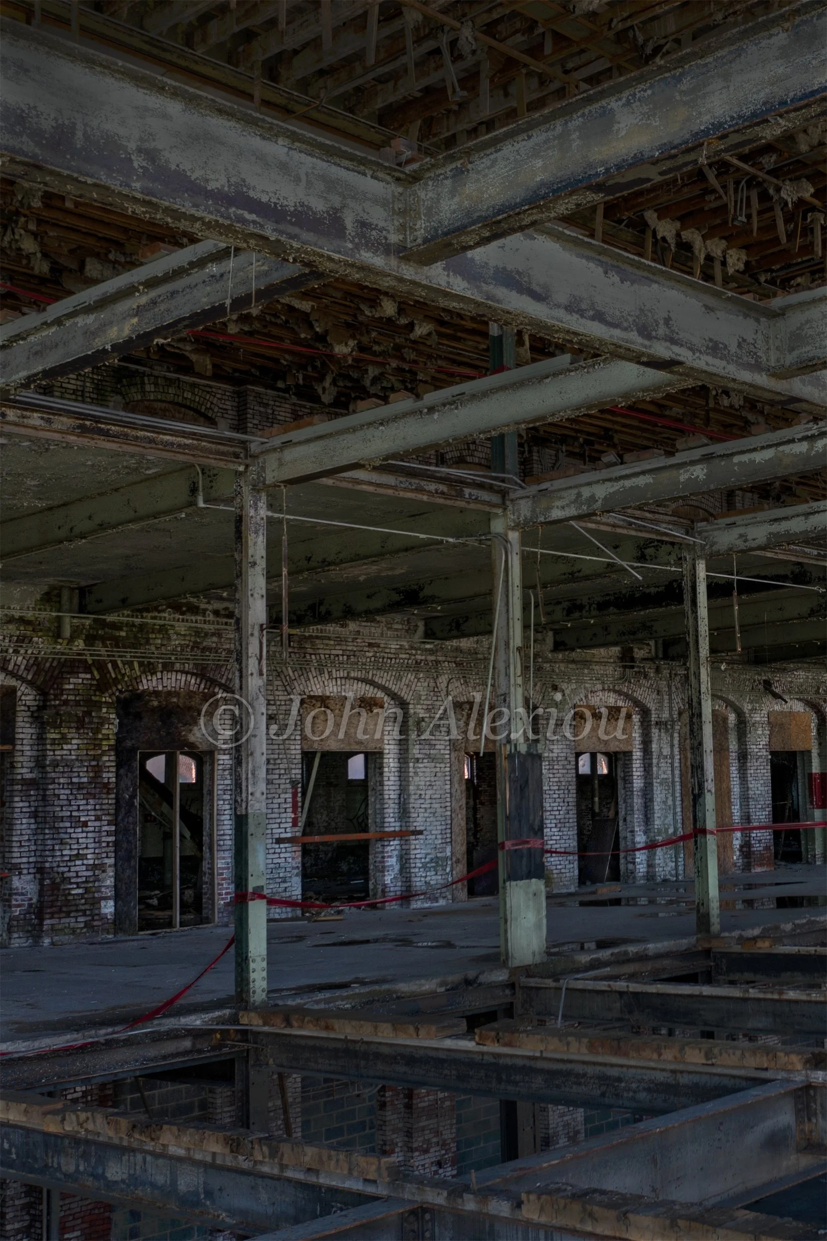 13 · The Frame Remains
A tall view into the factory reveals its exposed roof structure, columns and open floor bays.
© John Alexiou · 2019 · Scranton Lace Company