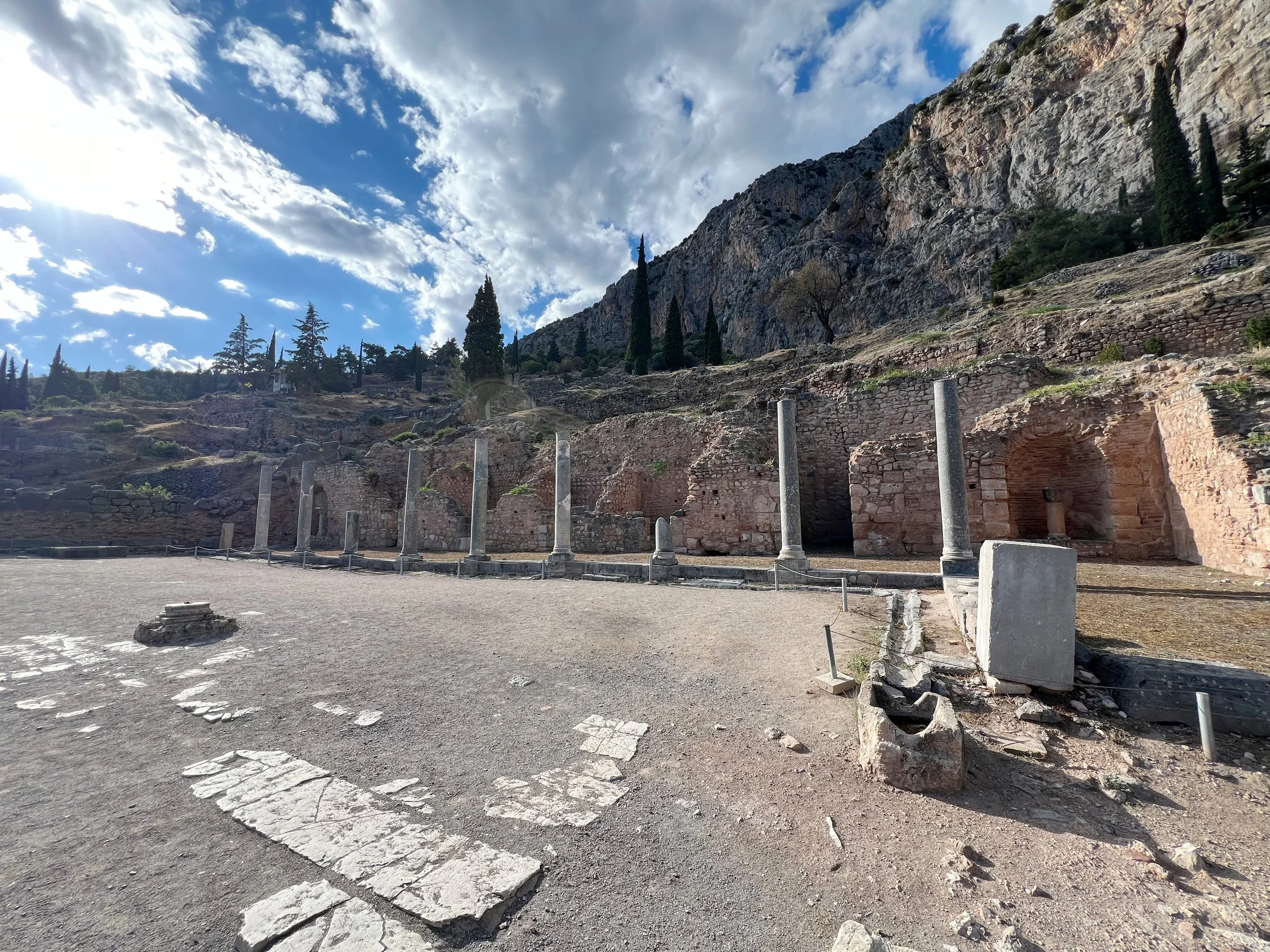 06 · Along the Sanctuary Wall
Slender columns lead across an open stone court beneath a steep rock face.
2024 · Greece
iPhone 13 Pro Max · 1.6 mm · f/1.8 · 1/896 s · ISO 32