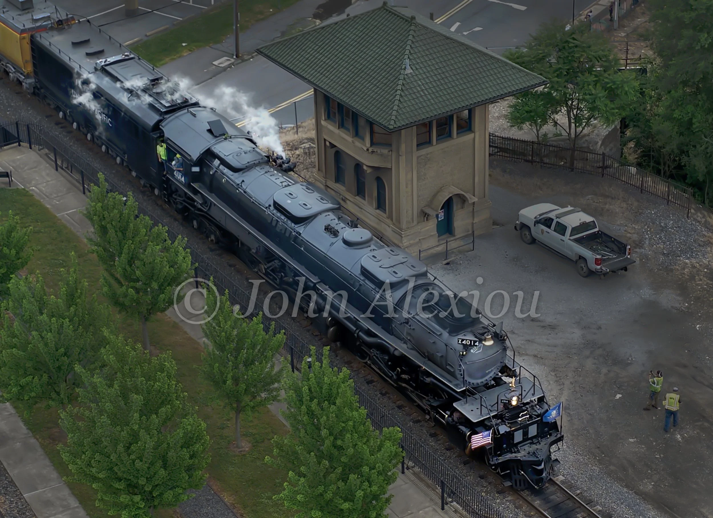 10 · The Scale of the Machine
Big Boy No. 4014 fills the track beside a green-roofed tower, with steam drifting above its long boiler.
© John Alexiou · 2026 · Steamtown, Scranton