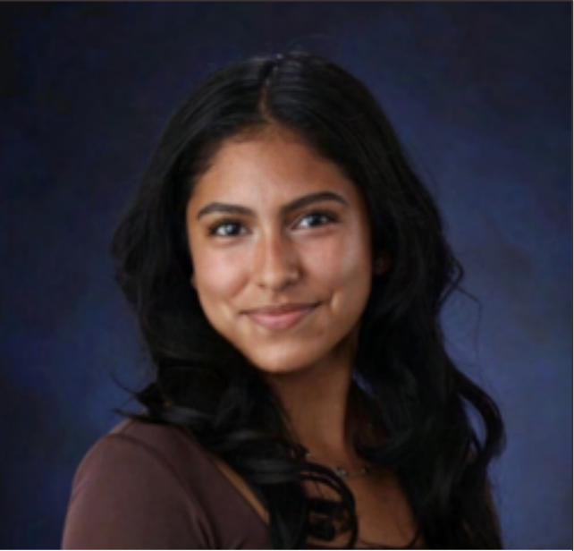 A young woman with long dark hair, smiling, against a dark blue background.