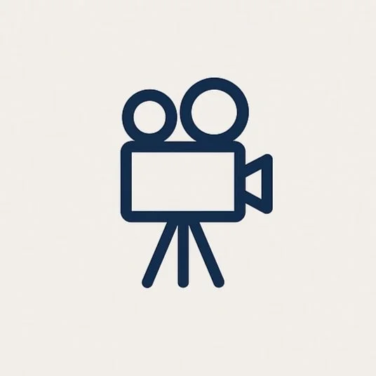 Icon of a movie camera with two reels on top and a tripod stand.