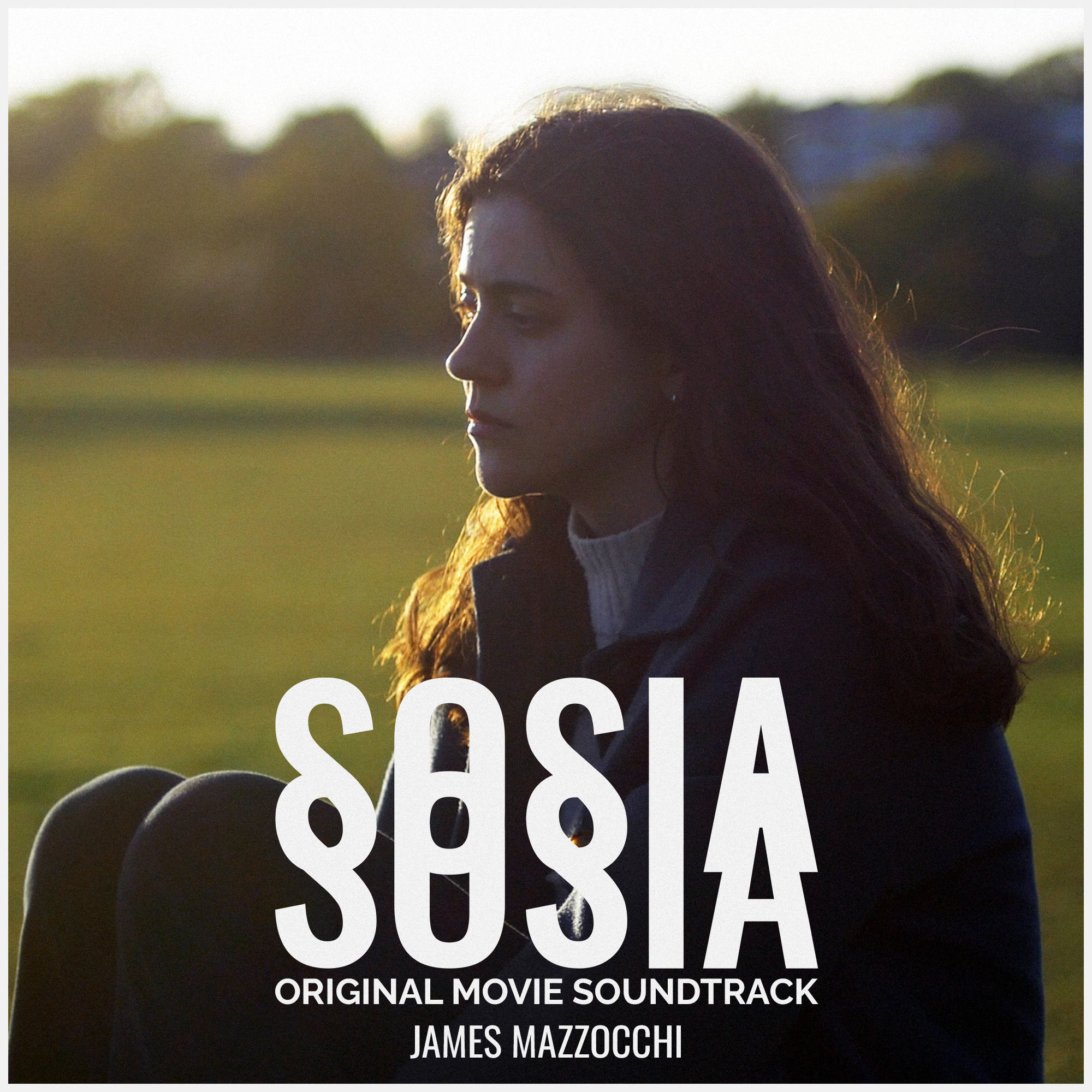 A young woman with dark brown hair sits outdoors in a grassy field during sunset, with her eyes closed and a peaceful expression, promoting the original soundtrack for the movie 'Sosía' composed by James Mazzocchi.