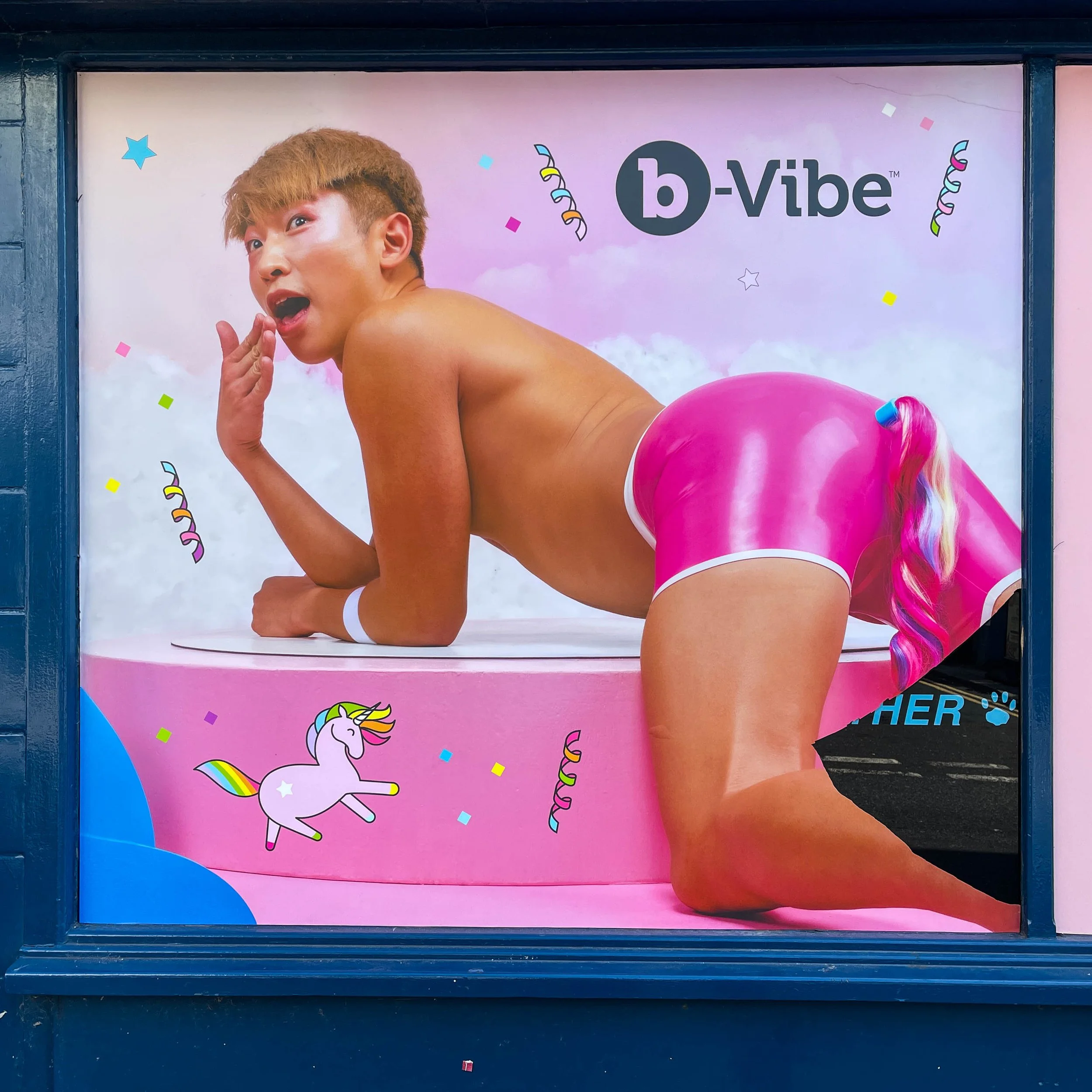 Street art in Brighton. Young man with tight pink shorts.