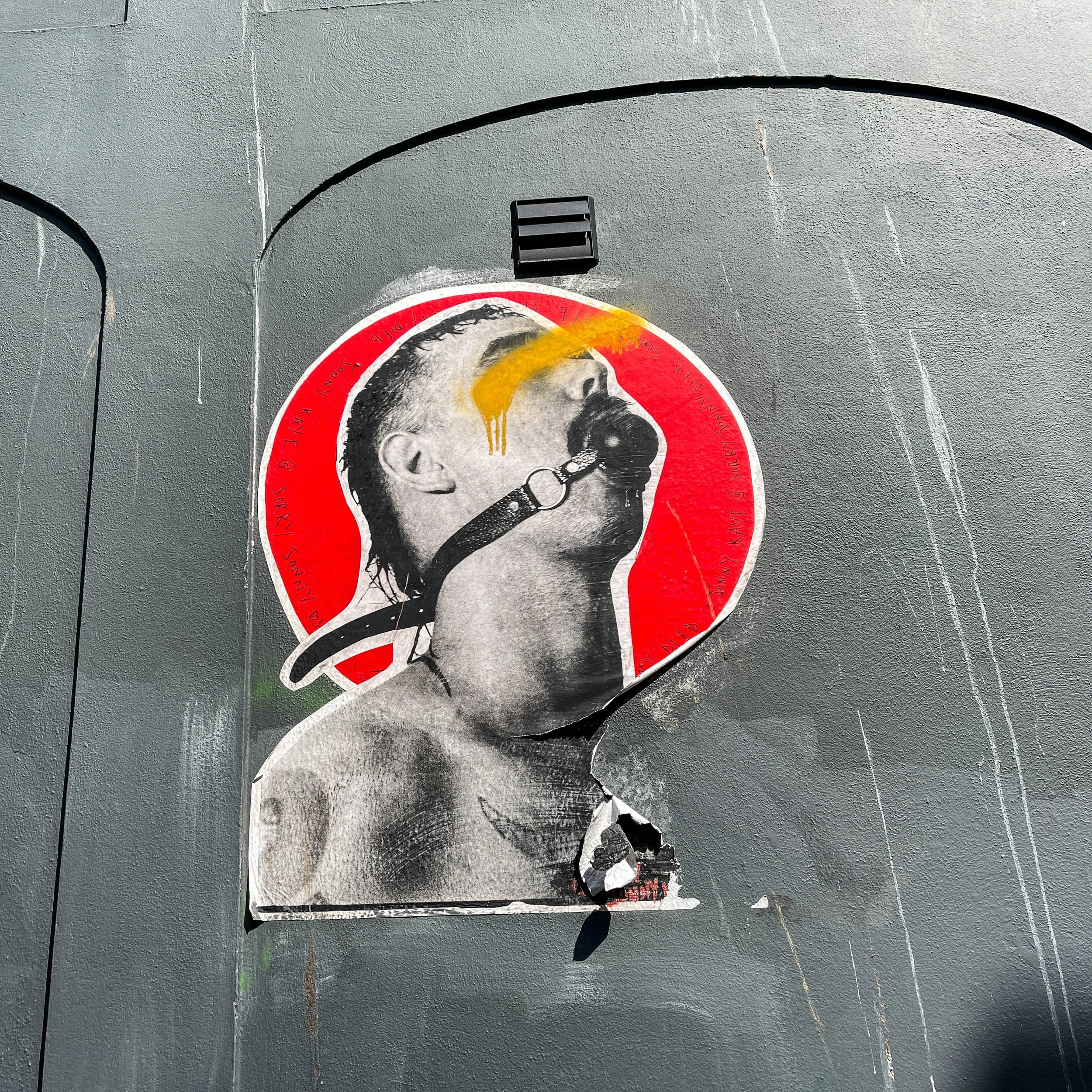 Street art in Brighton. Man's head with ball gag.