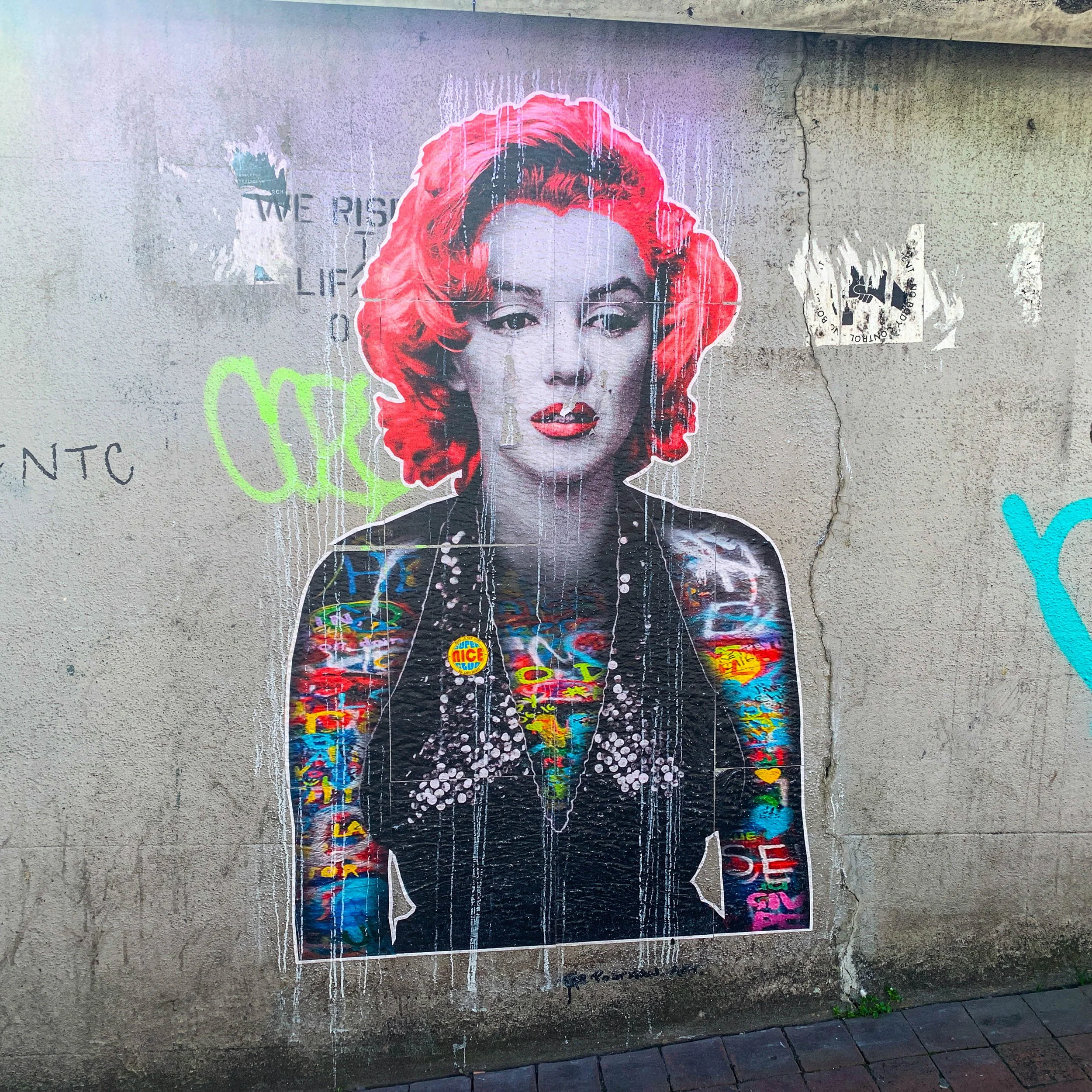Street art in Brighton. Woman with red hair on grey background.
