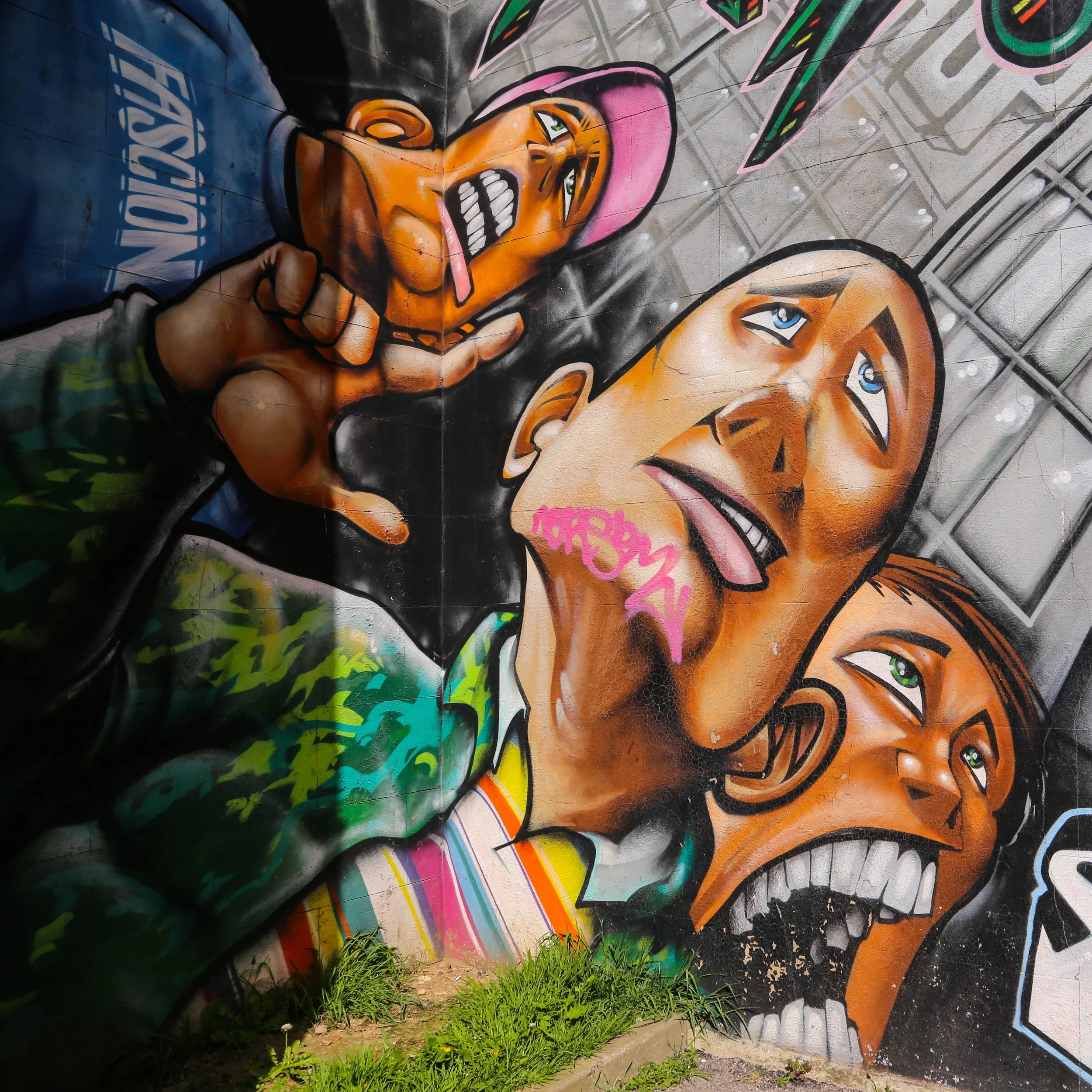 Street art in Brighton. Three men's faces.