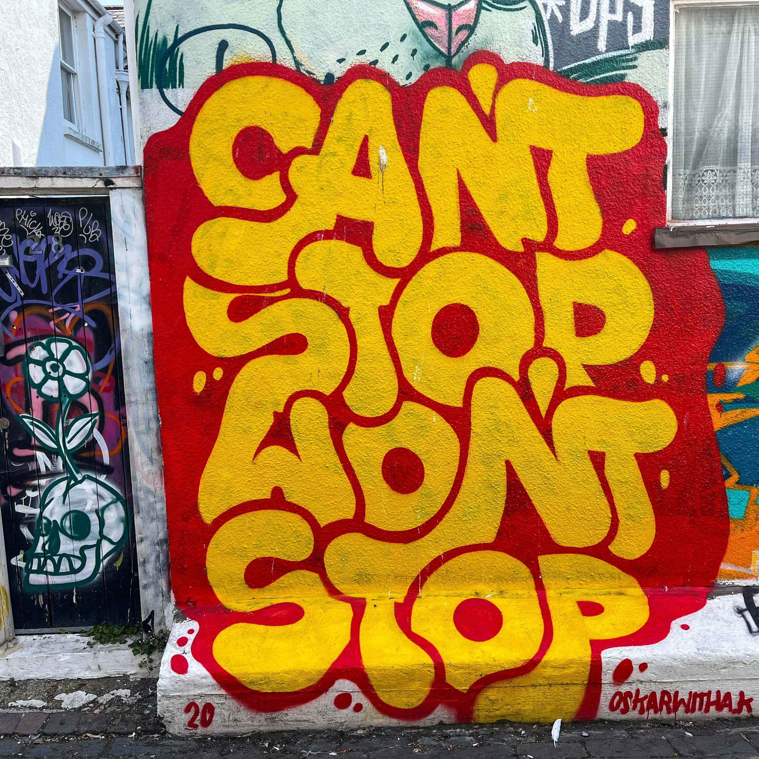 Street art in Brighton. Can't stop won't stop. Red and yellow.