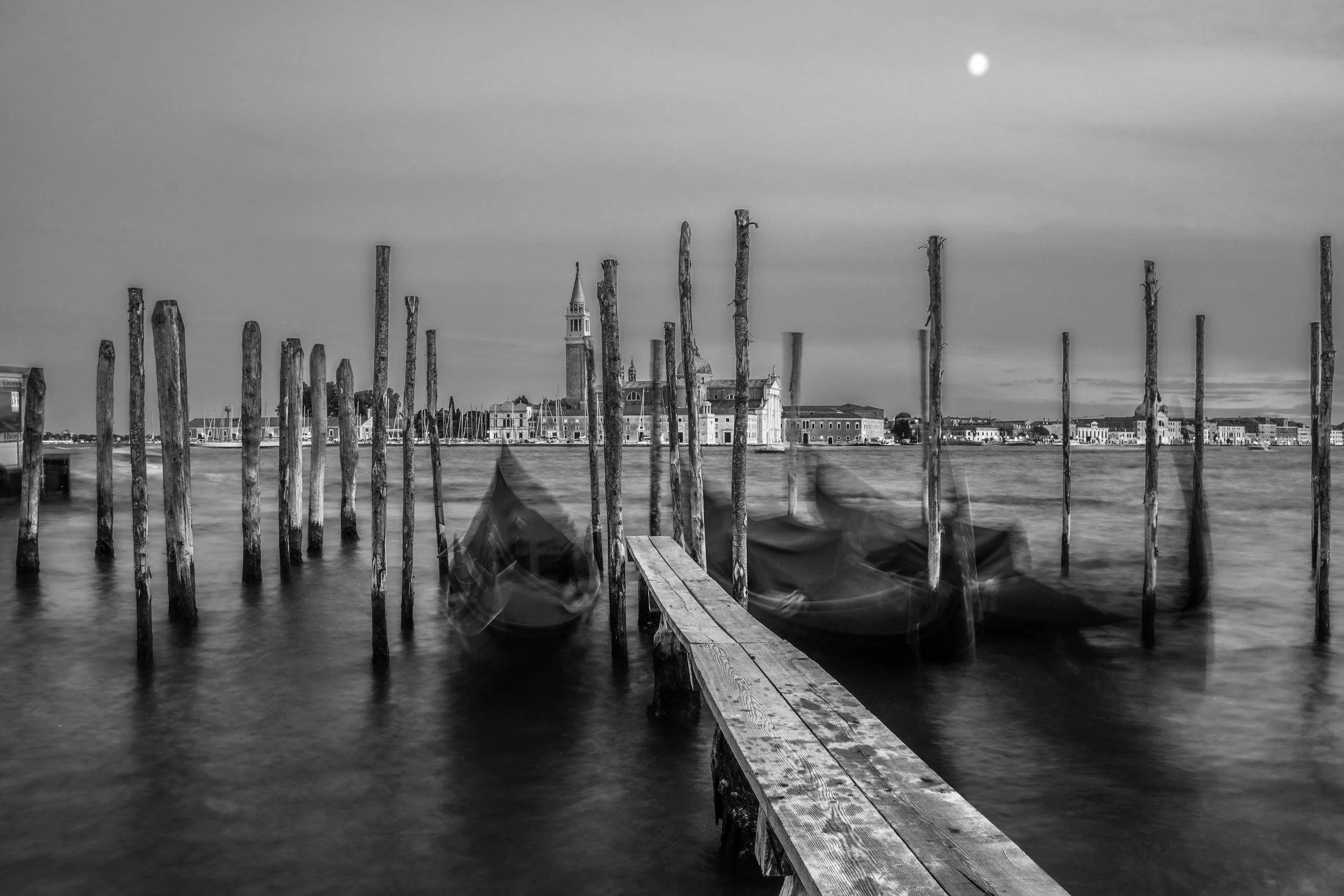 Gondolas gently bobbing on the canal in Venice.