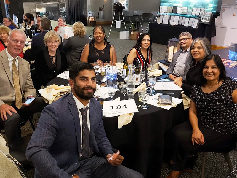 Maya with friends and family at a community event