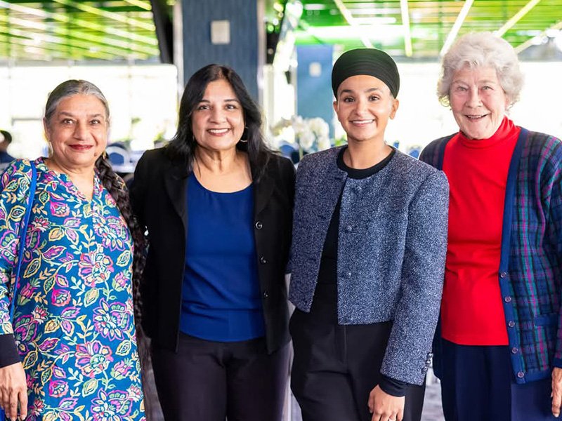 Maya with community members at a gathering