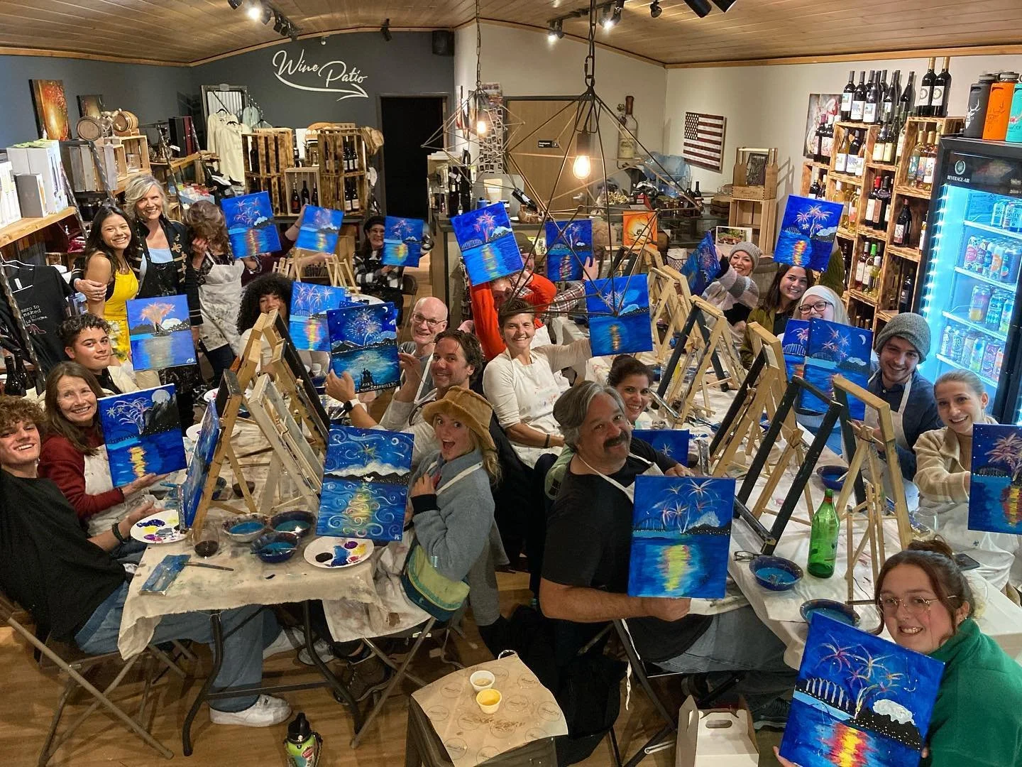 A full room of people at a paint and sip night