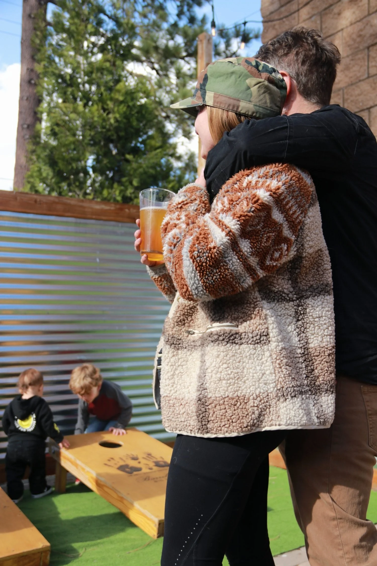 Man with arm slung over woman outside enjoying the patio.