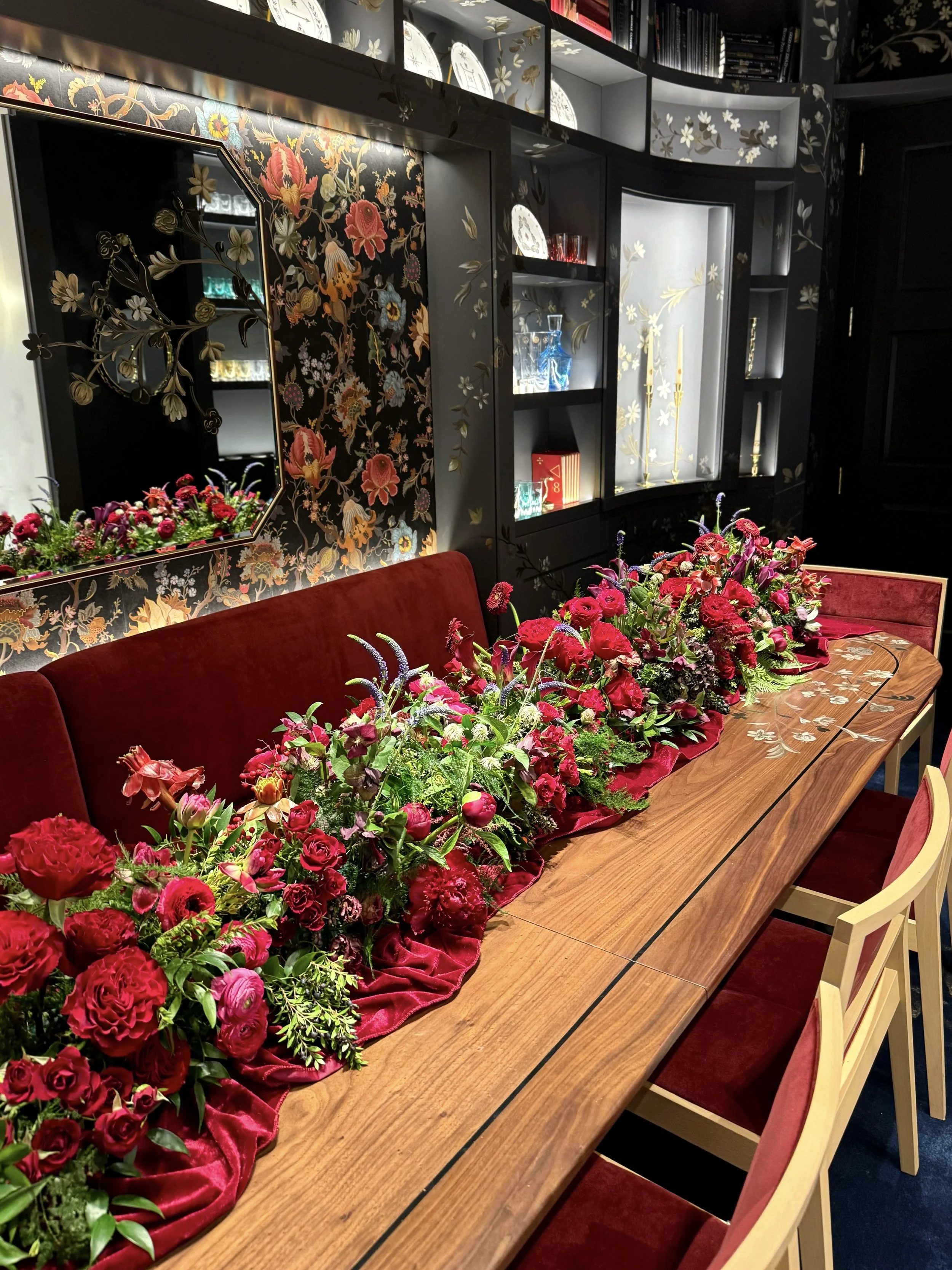  burgundy floral table runner at a moody restaurant reception 